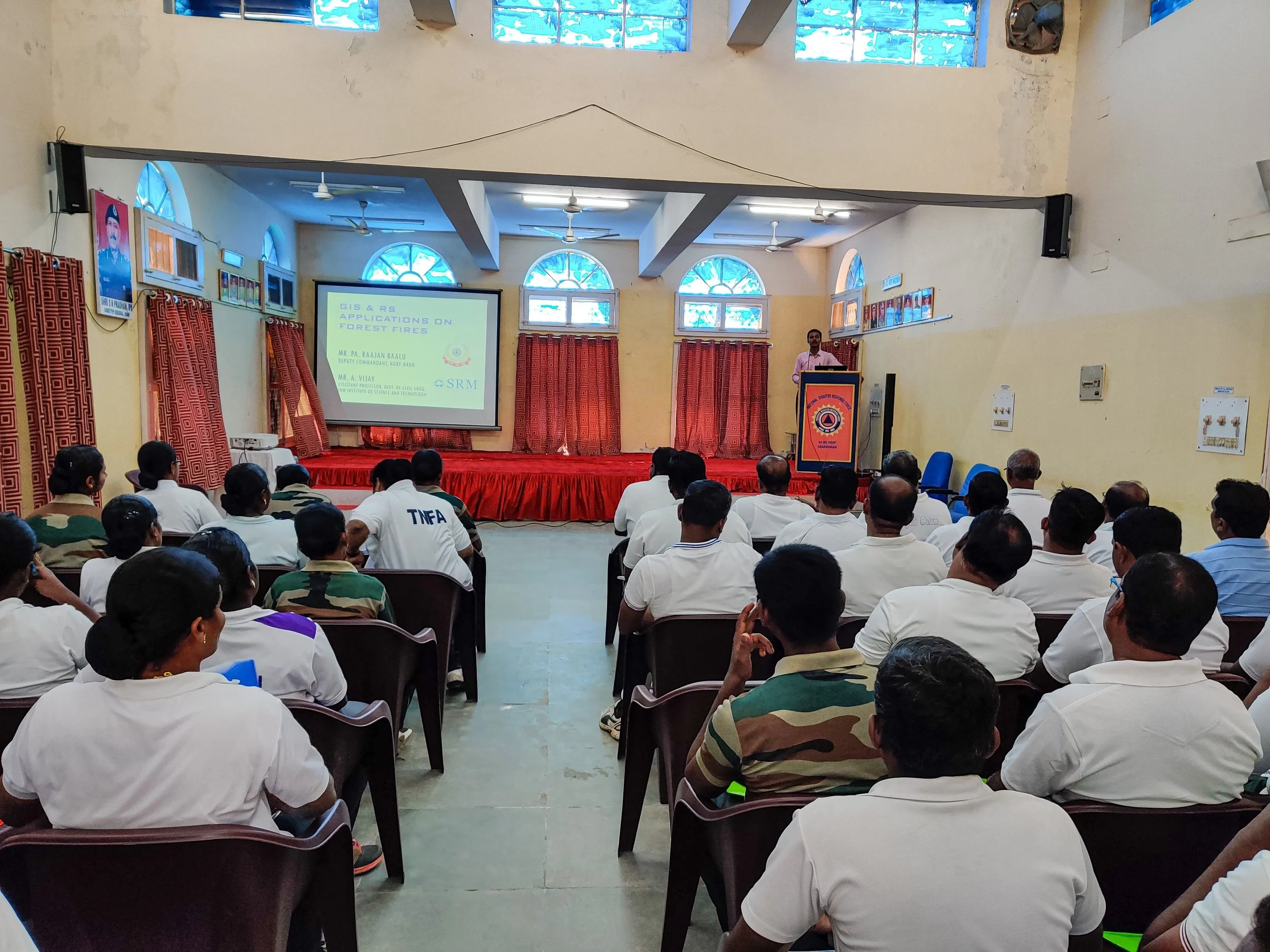 An educational workshop with NDRF officers in a training hall
