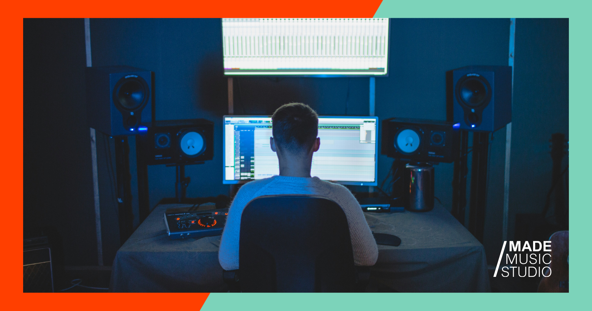 A man sitting at a desk, focused on a computer screen in front of him.