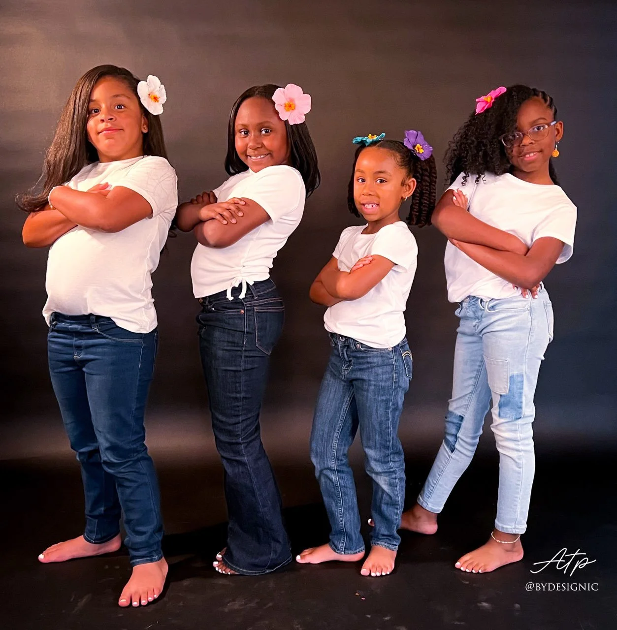 Four young clients displaying their hairstyles from the front