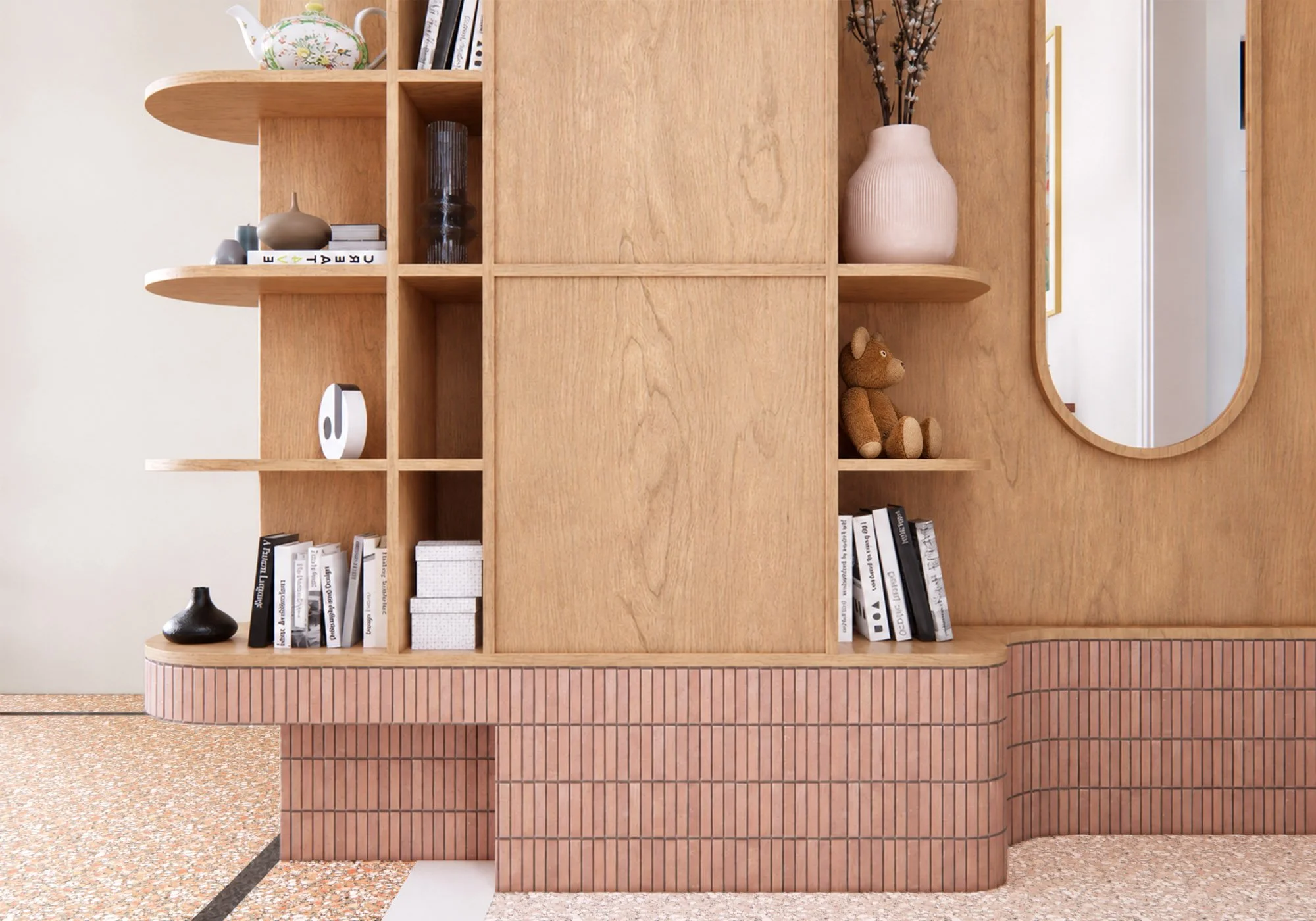 Detail of custom timber entrance cabinetry and shelving with curved pink tiled base, integrated mirror and terrazzo flooring.