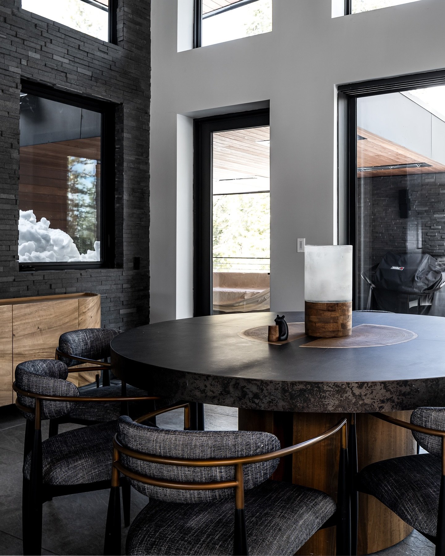Modern architecture at its calmest, richest, most refined.

This home is a study in modern restraint: deep charcoal cabinetry, warm walnut tones, sculptural stonework, and lighting that softens every edge. Each furnishing and finish was chosen to ele