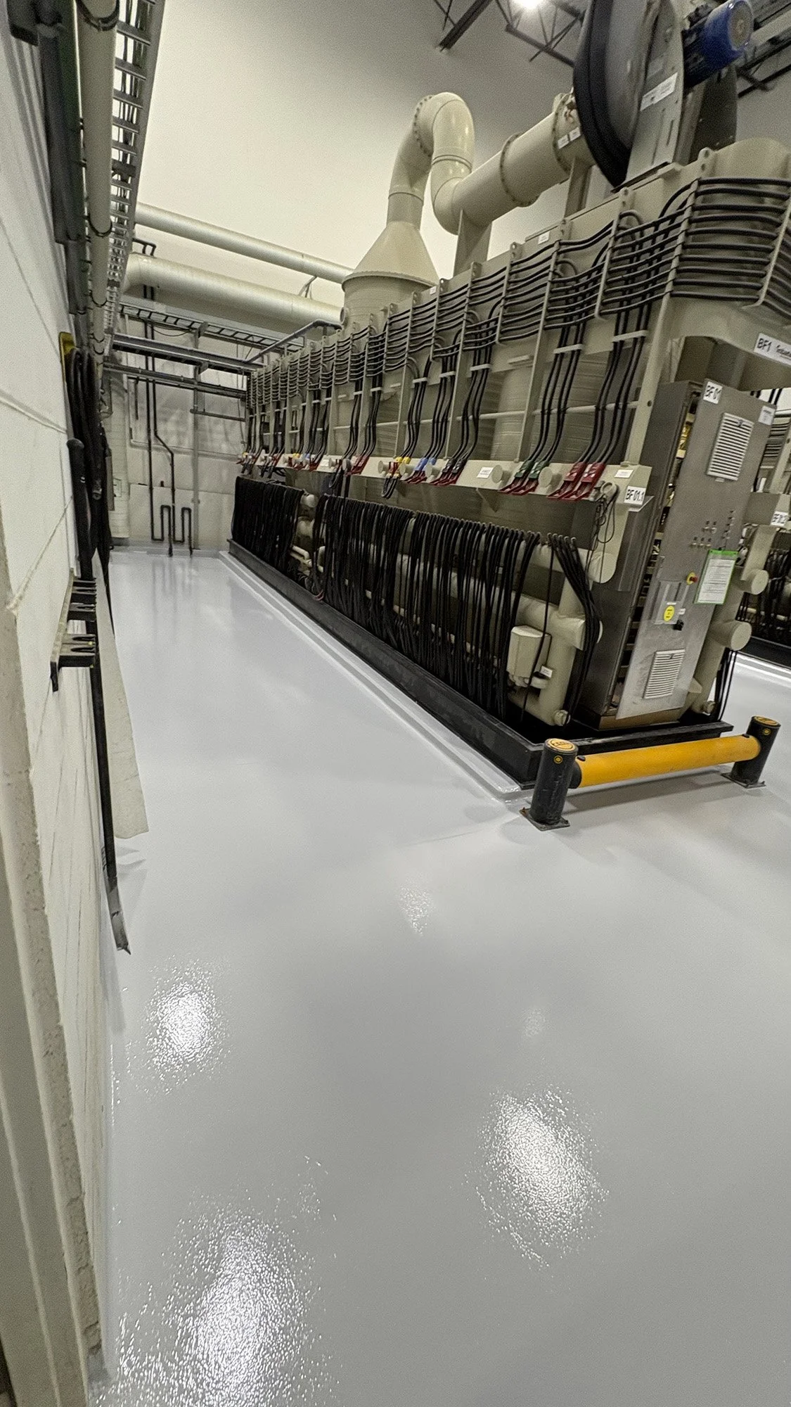 Electrical equipment with numerous wires and cables inside a data center or industrial facility.