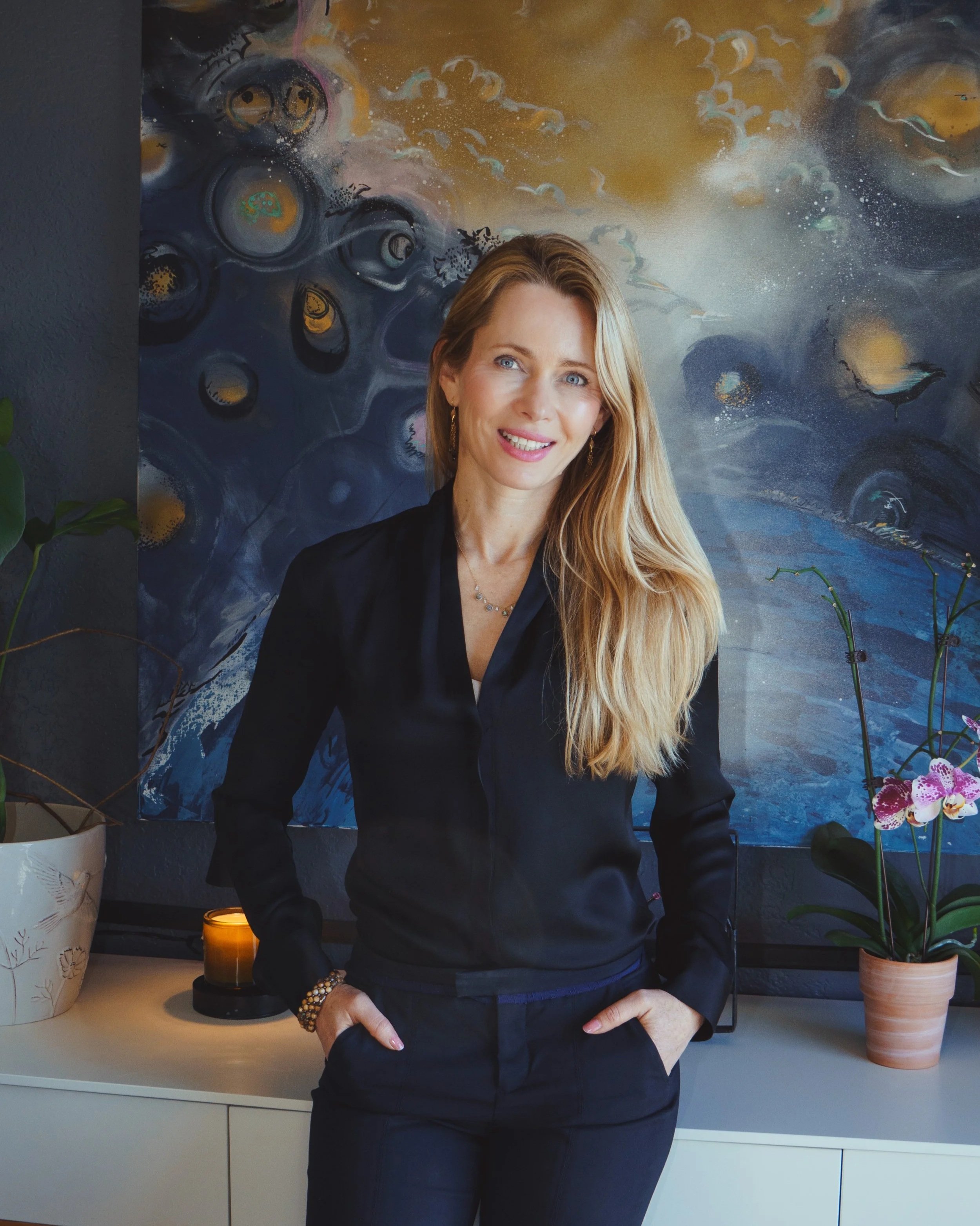 Regina Abayev, JD, LMFT Standing in her Hermosa Beach Office by her Desk