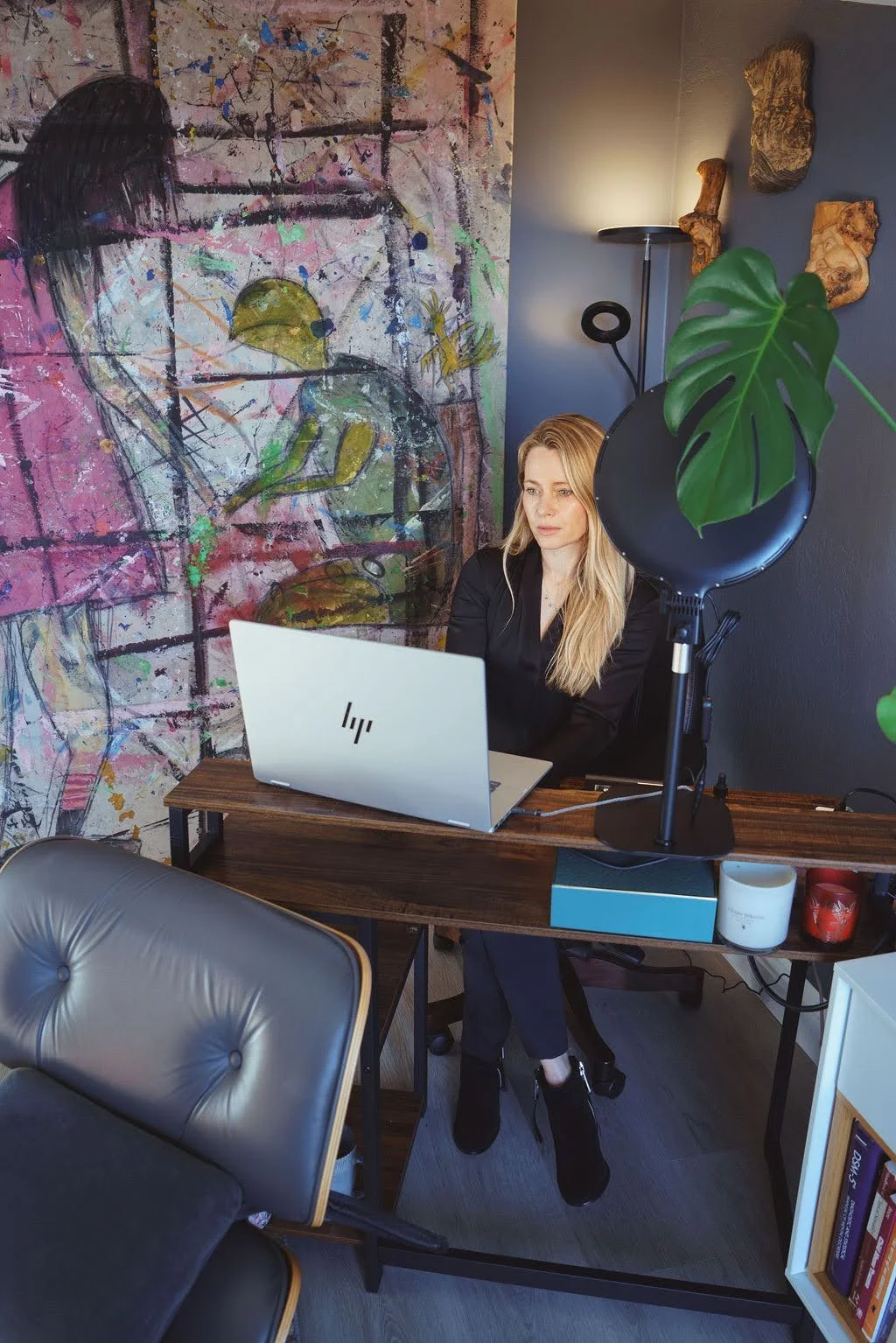 Regina Abayev at her desk during a virtual therapy session