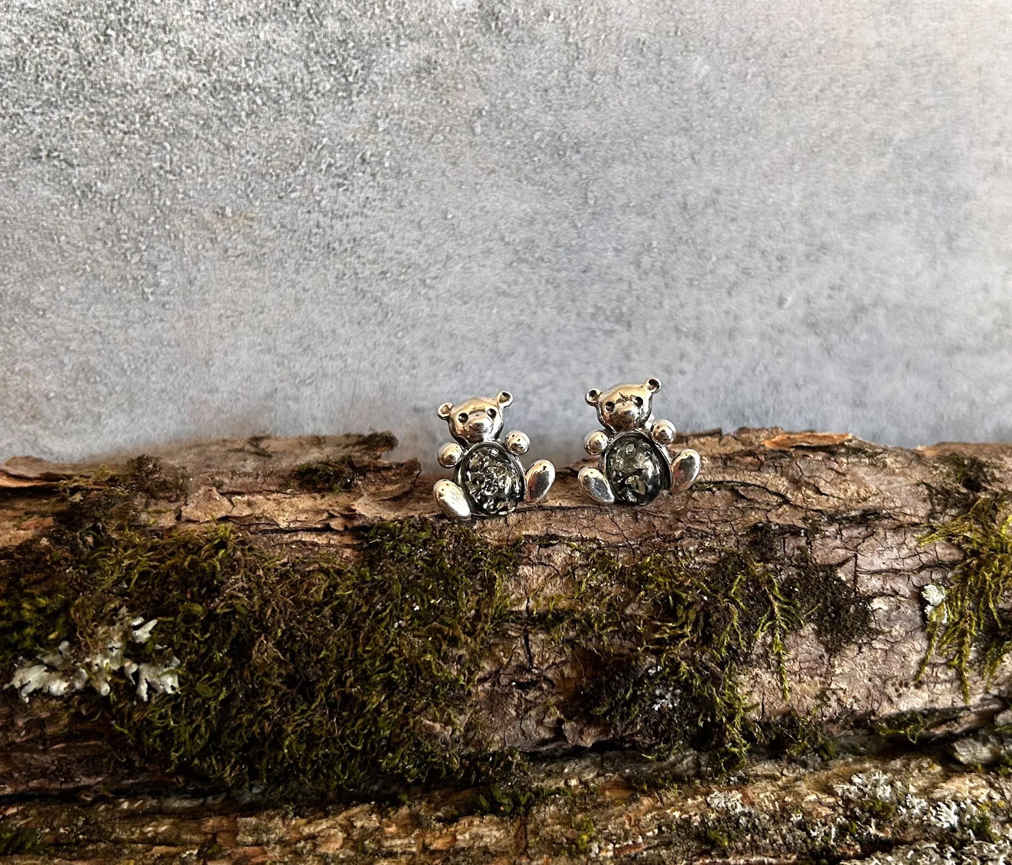 Teddy bear shaped silver stud earrings with green amber