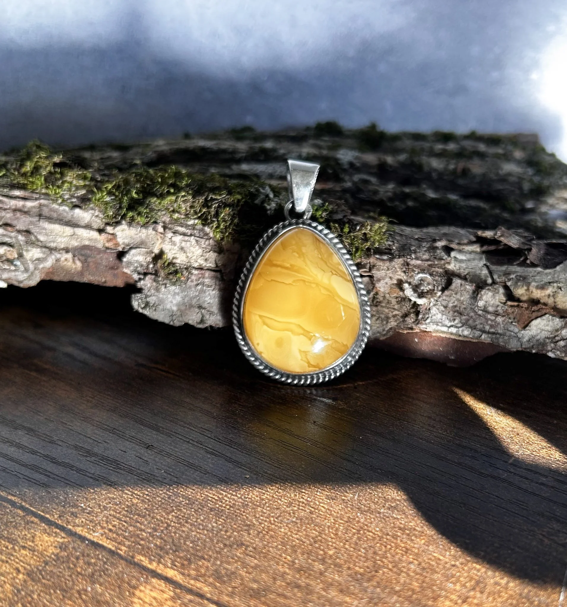 Tear shaped butterscotch-yellow Baltic amber pendant in silver