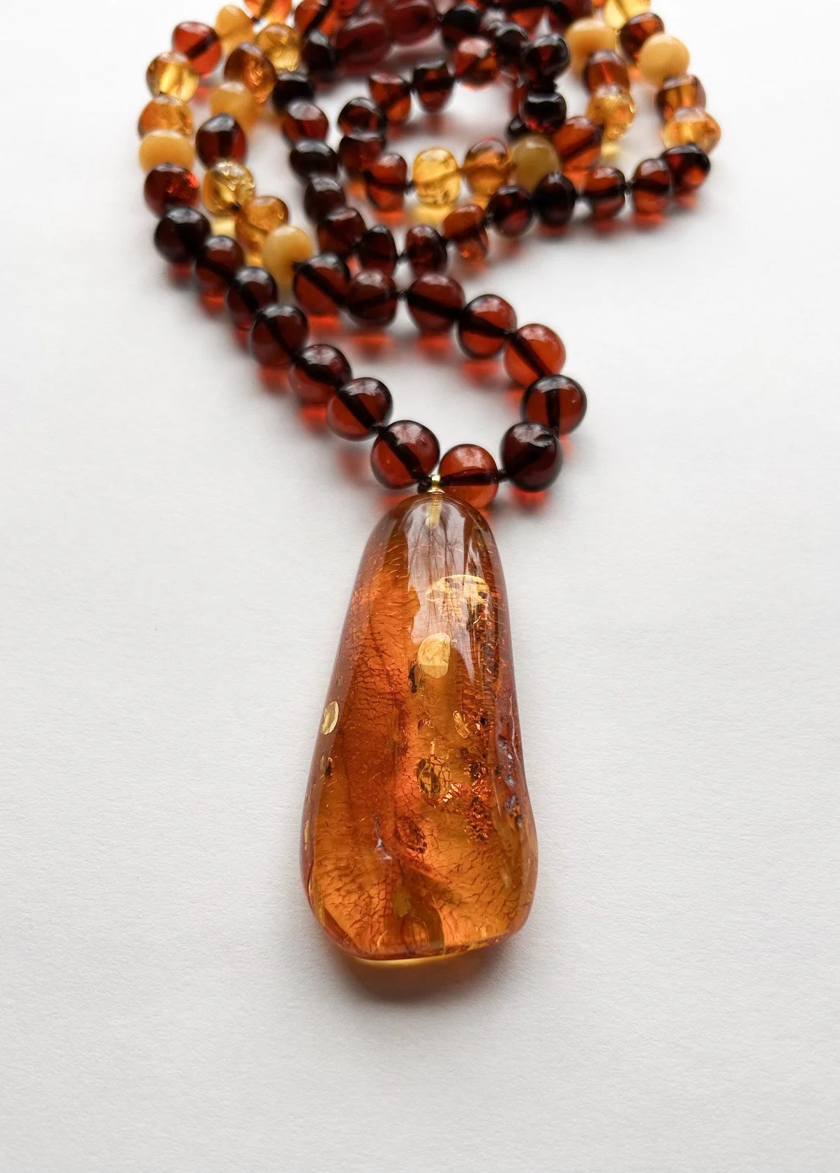 Beaded Baltic amber necklace with a large light cognac pendant