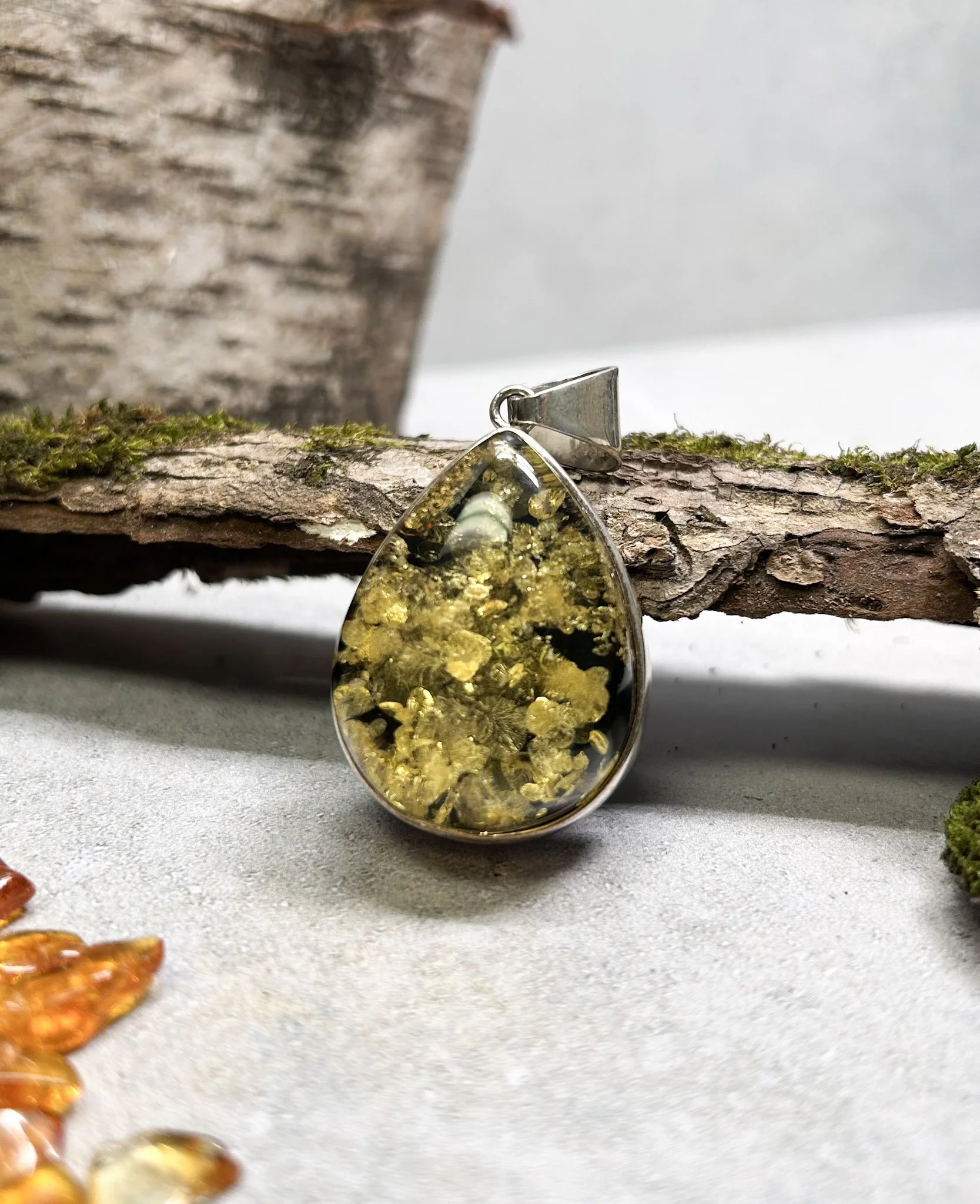 Tear shaped green Baltic amber pendant in silver