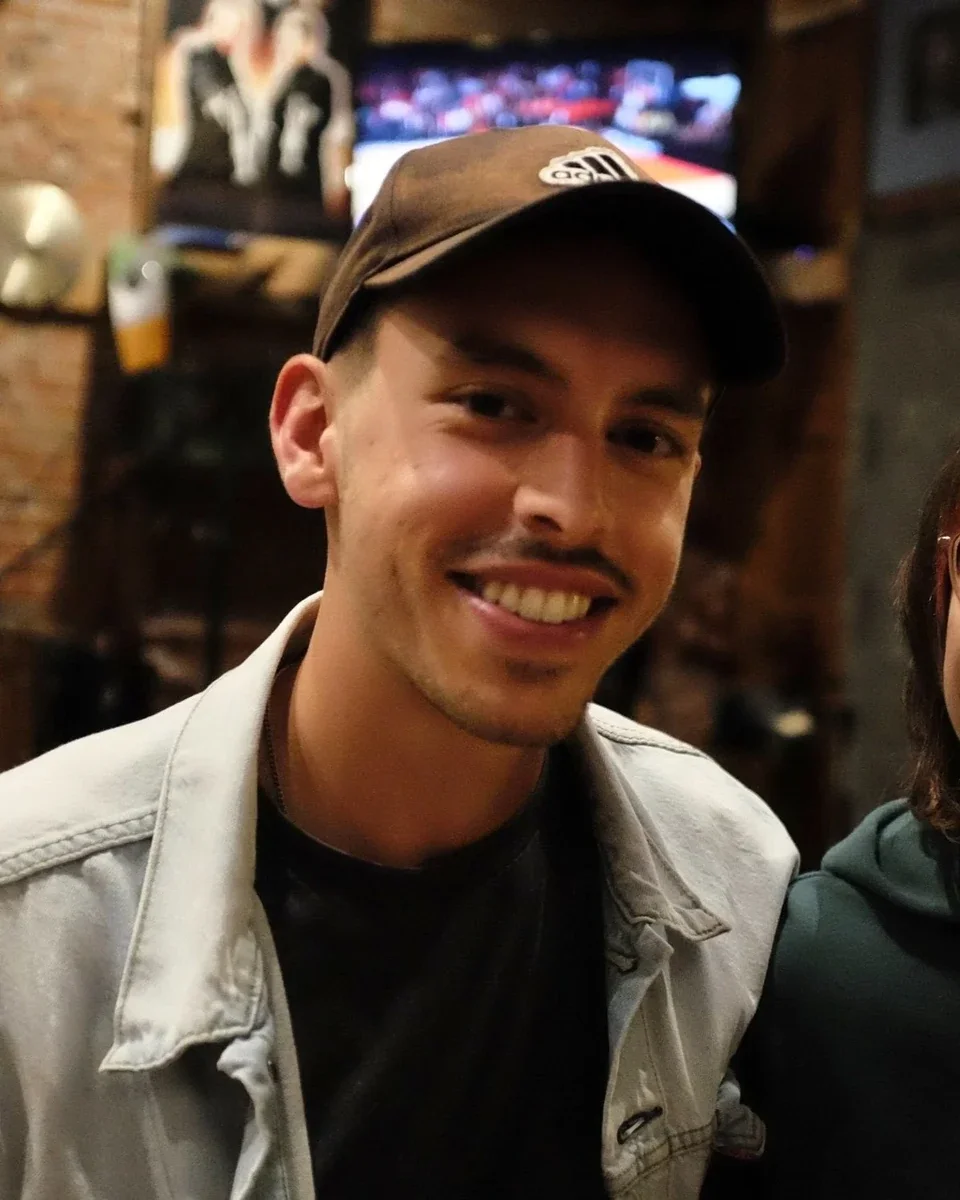 Xavier Pereira, Alpine Roots co-founder, smiling in a brown cap and light denim jacket