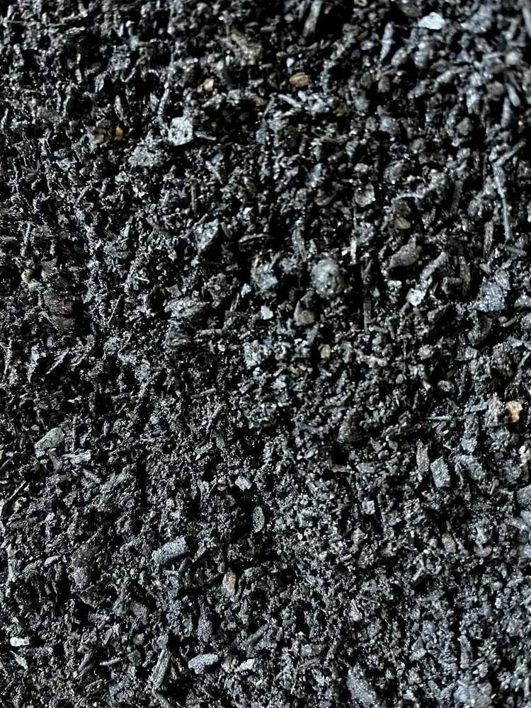 acro close-up of fine, glittering black biochar particles