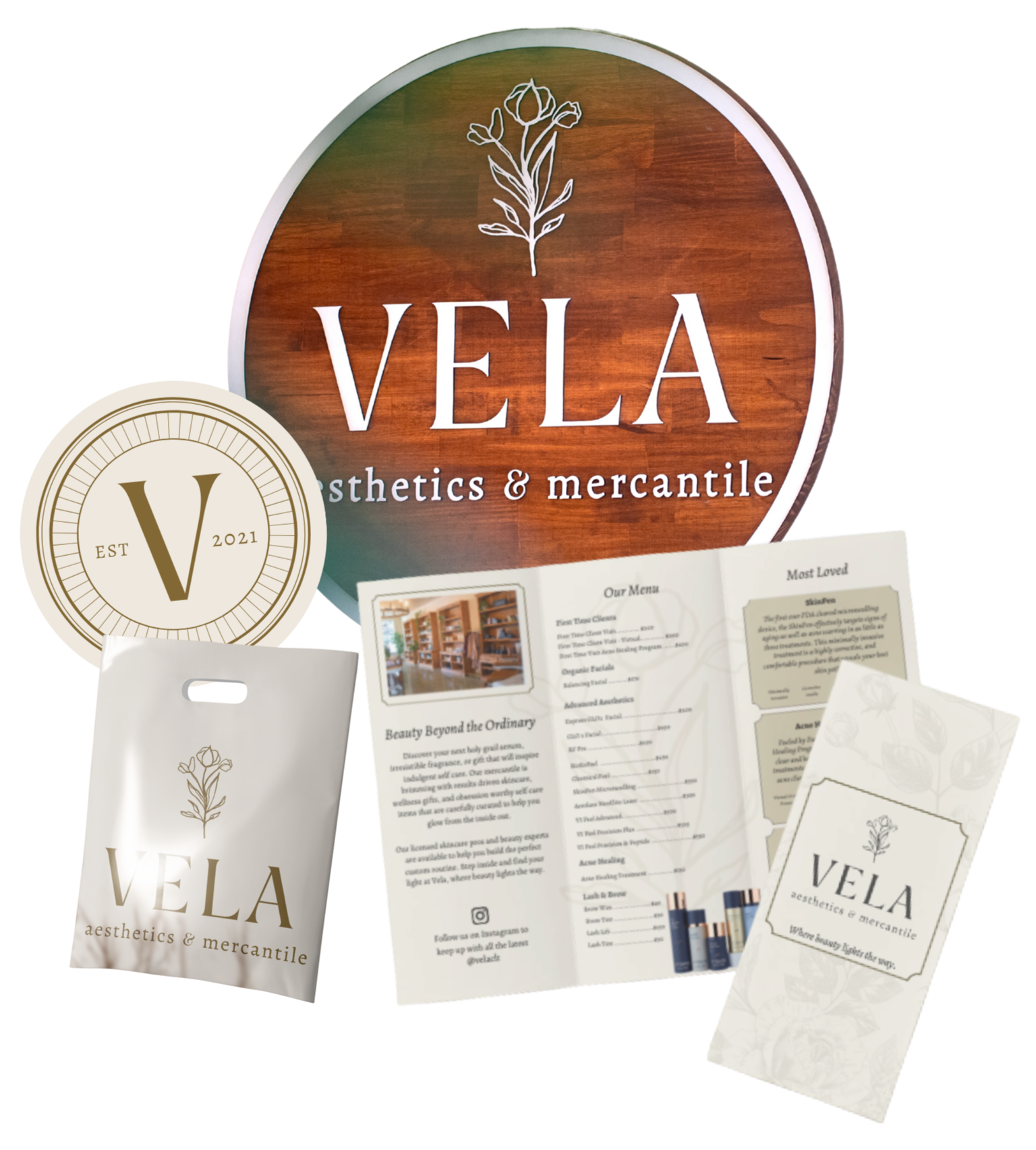 Branding and marketing materials for VELA aesthetics & mercantile, including a large round sign, a smaller circular logo, a paper shopping bag, a menu, and a tall packet, all featuring a minimalist floral logo and elegant typography.