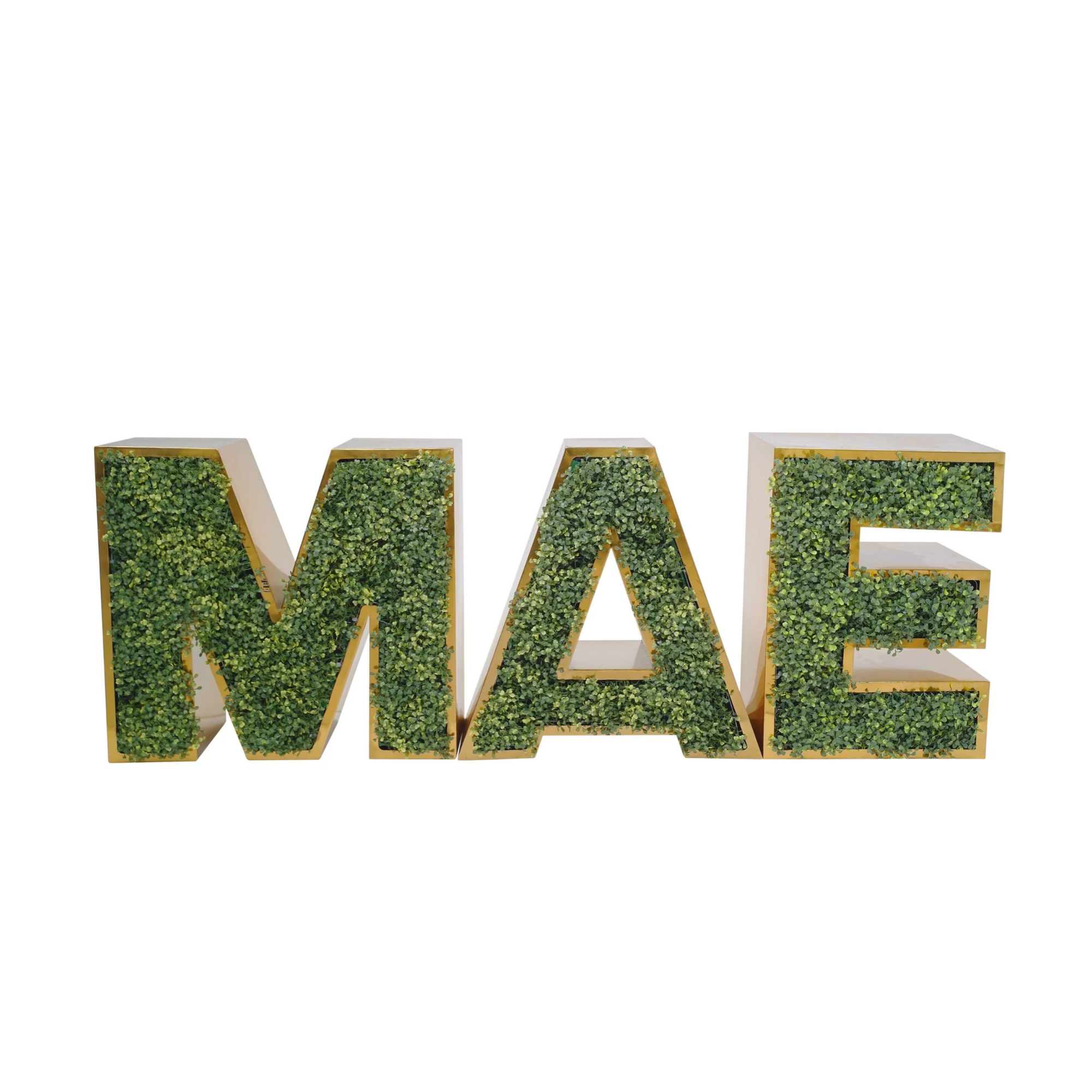 Large white sign spelling out the word "LOVE" with greenery inside the letters