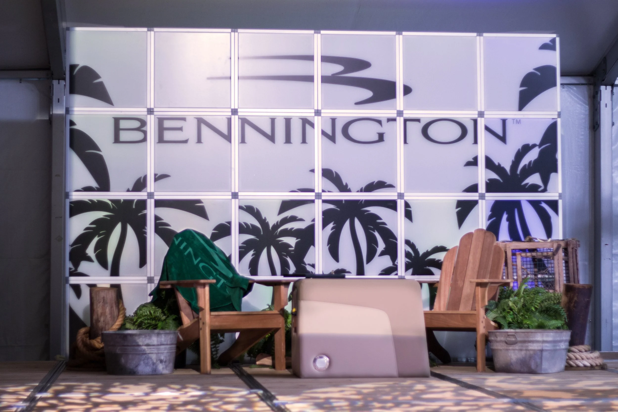 A sign with the word "BENNINGTON" and silhouettes of palm trees in the background.