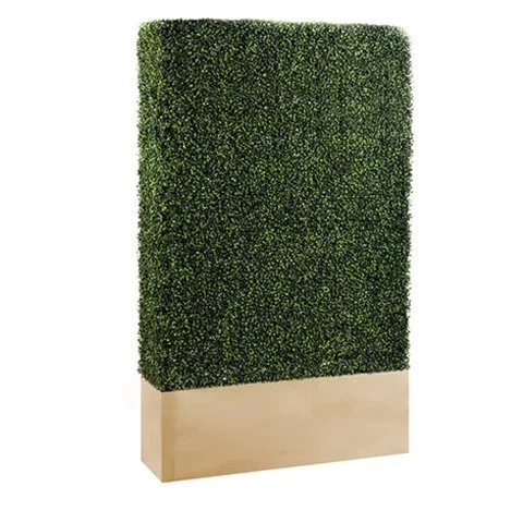 A tall rectangular decorative piece with a green foliage top and a wooden base.