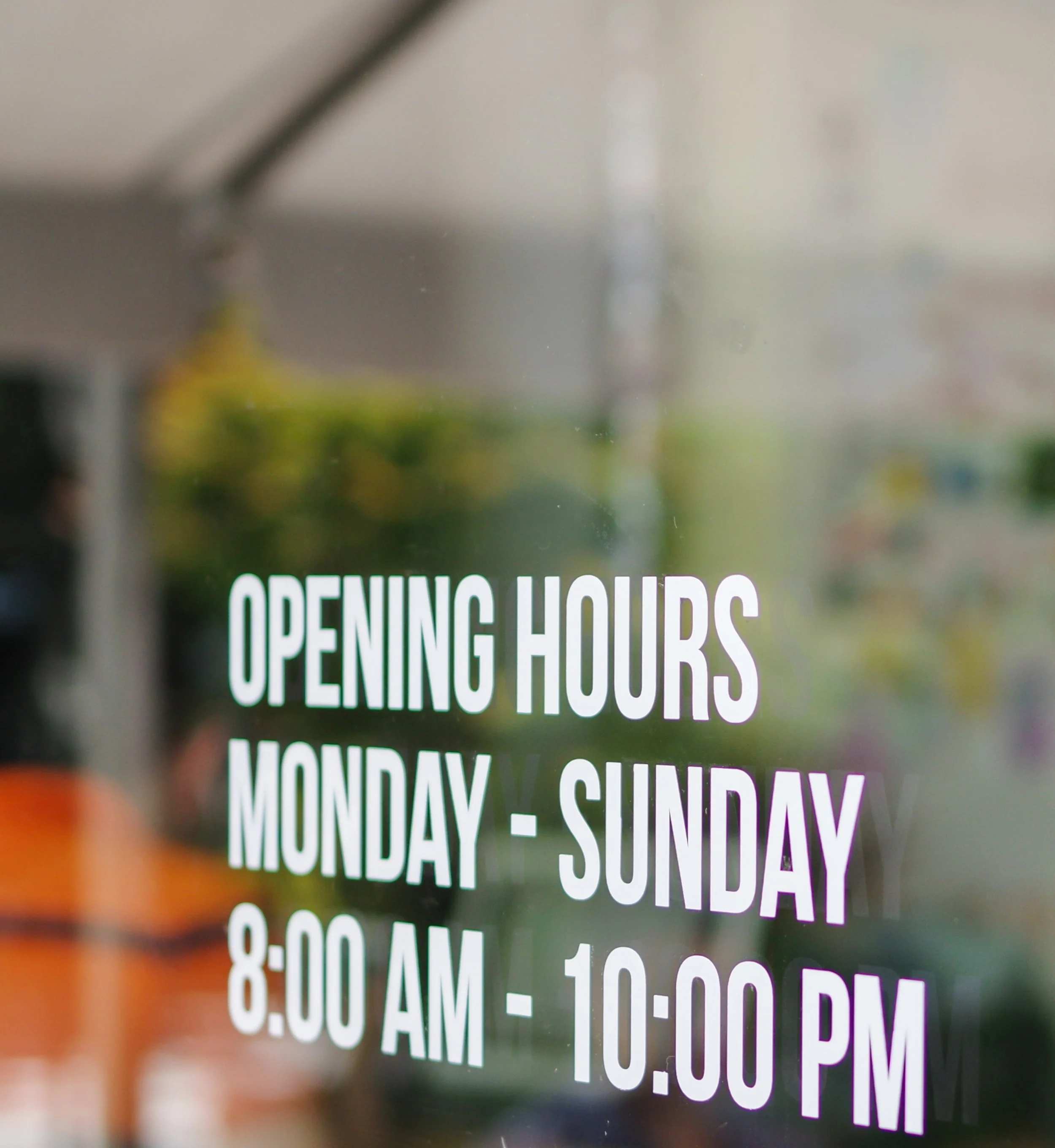 Sign with store hours: Open Monday to Sunday from 8:00 AM to 10:00 PM.