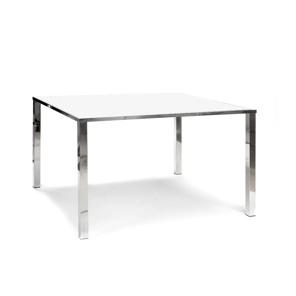 A modern rectangular table with a white top and metallic chrome legs.