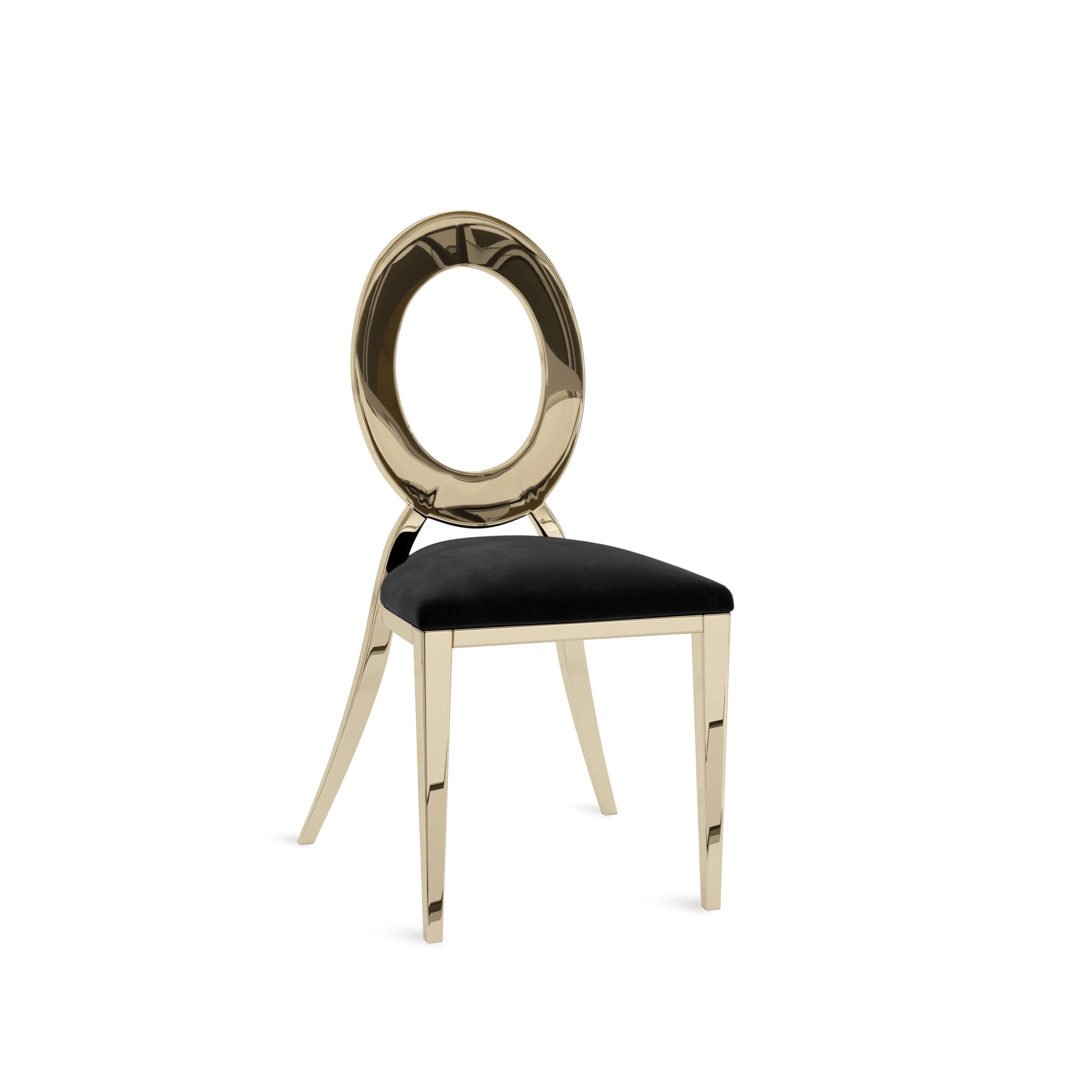A golden, reflective circular object, possibly a ring or a piece of jewelry, resting on a small chair with a black cushion.