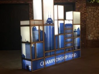 Display with a city skyline silhouette in blue and white, labeled 'Championship Fund' at the bottom.