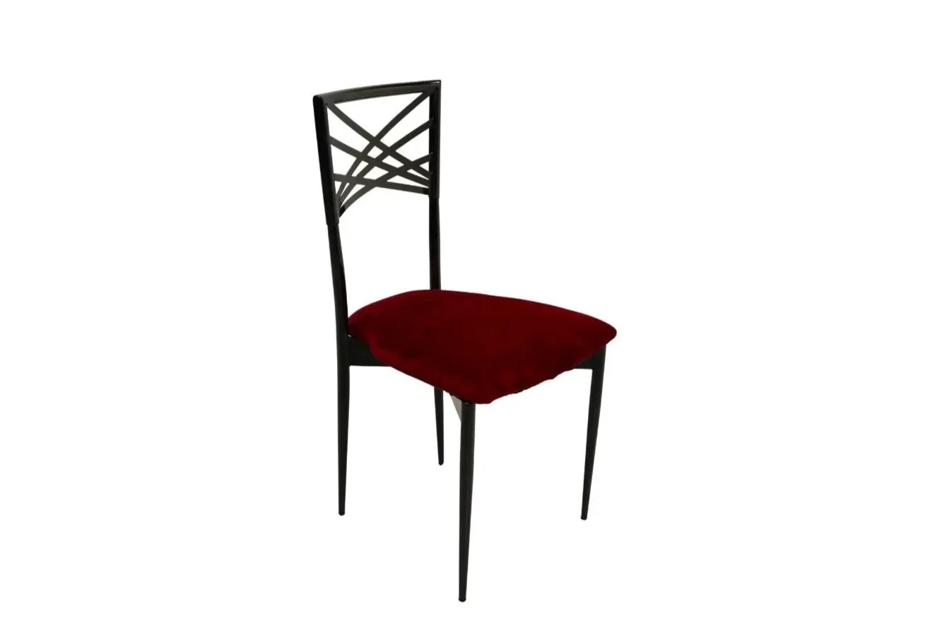 Black chair with a decorative backrest and a red cushioned seat against a white background.
