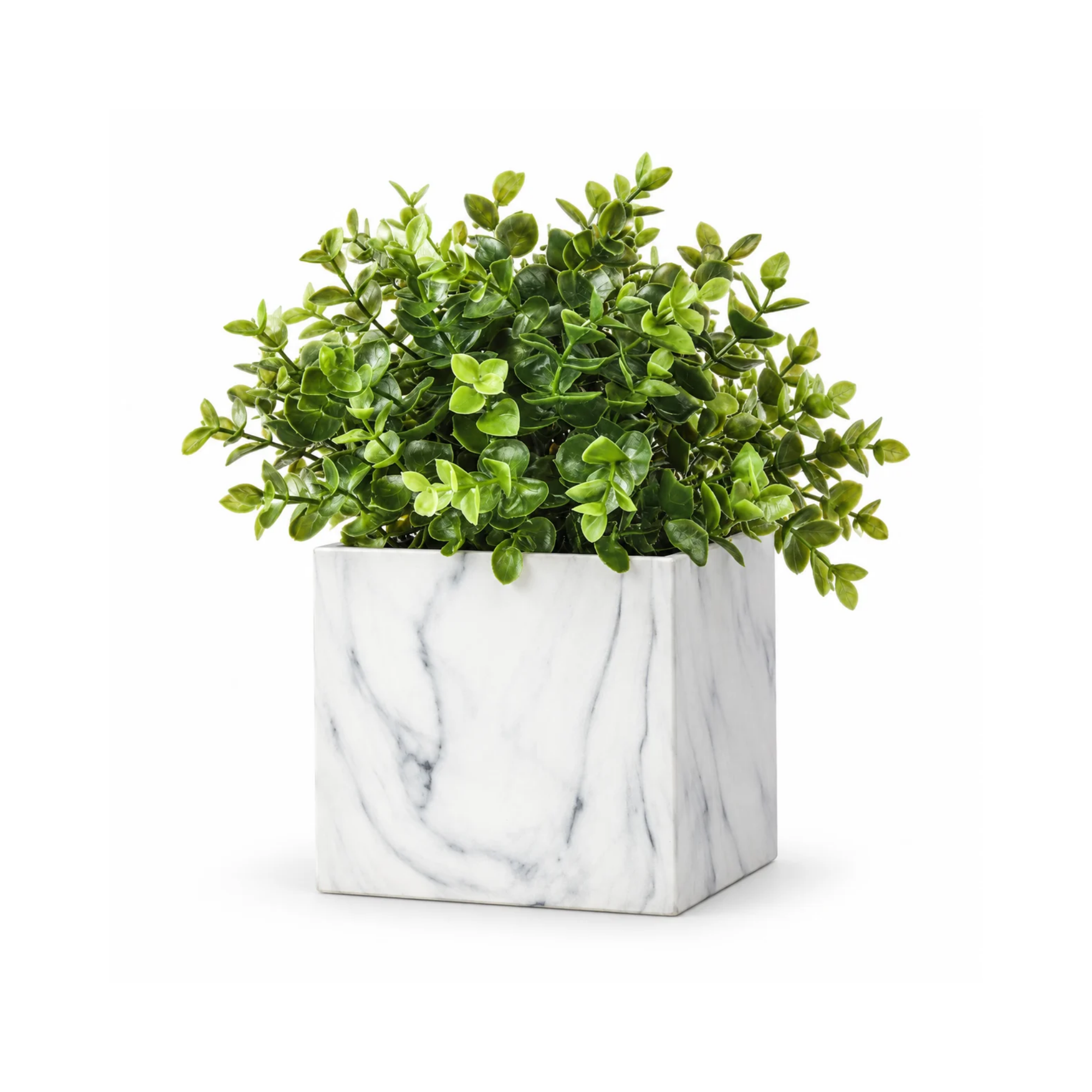 Artificial green plant in a white marble-patterned pot