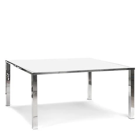 A modern rectangular table with a metallic frame and a white tabletop.
