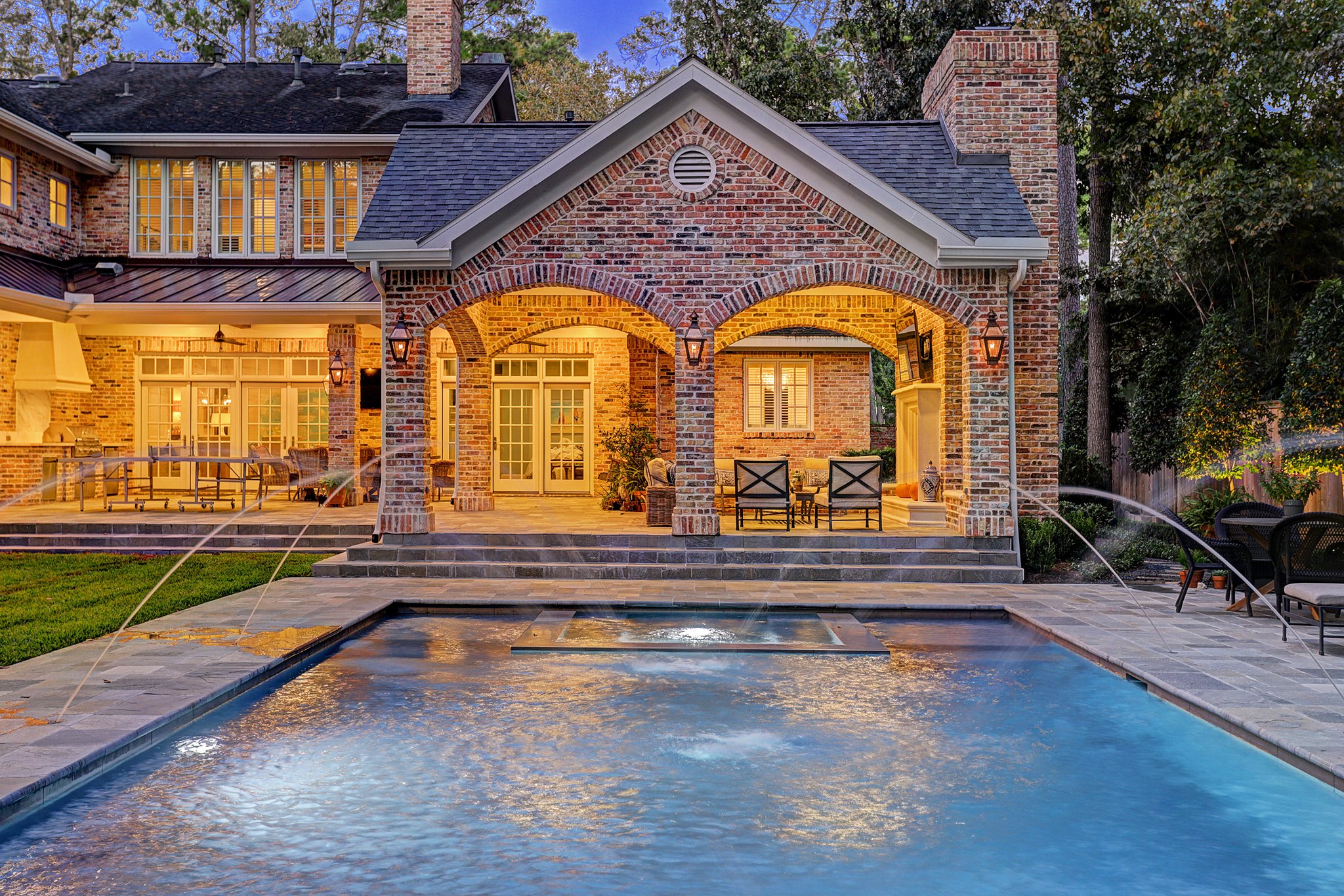 A Patio Cover and a Pool with Water Features