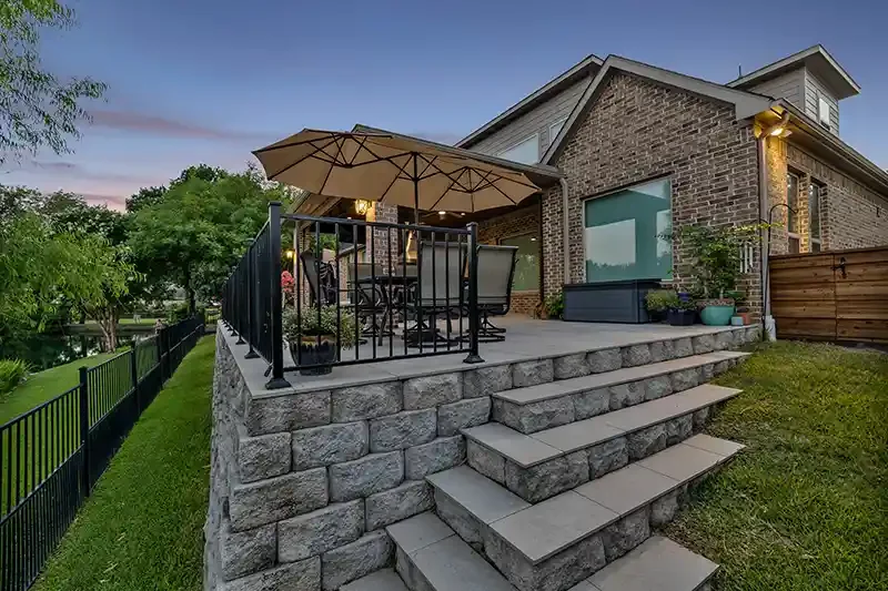 Retaining and Porcelain pavers hardscaping with elevated patio cover overlooking pond