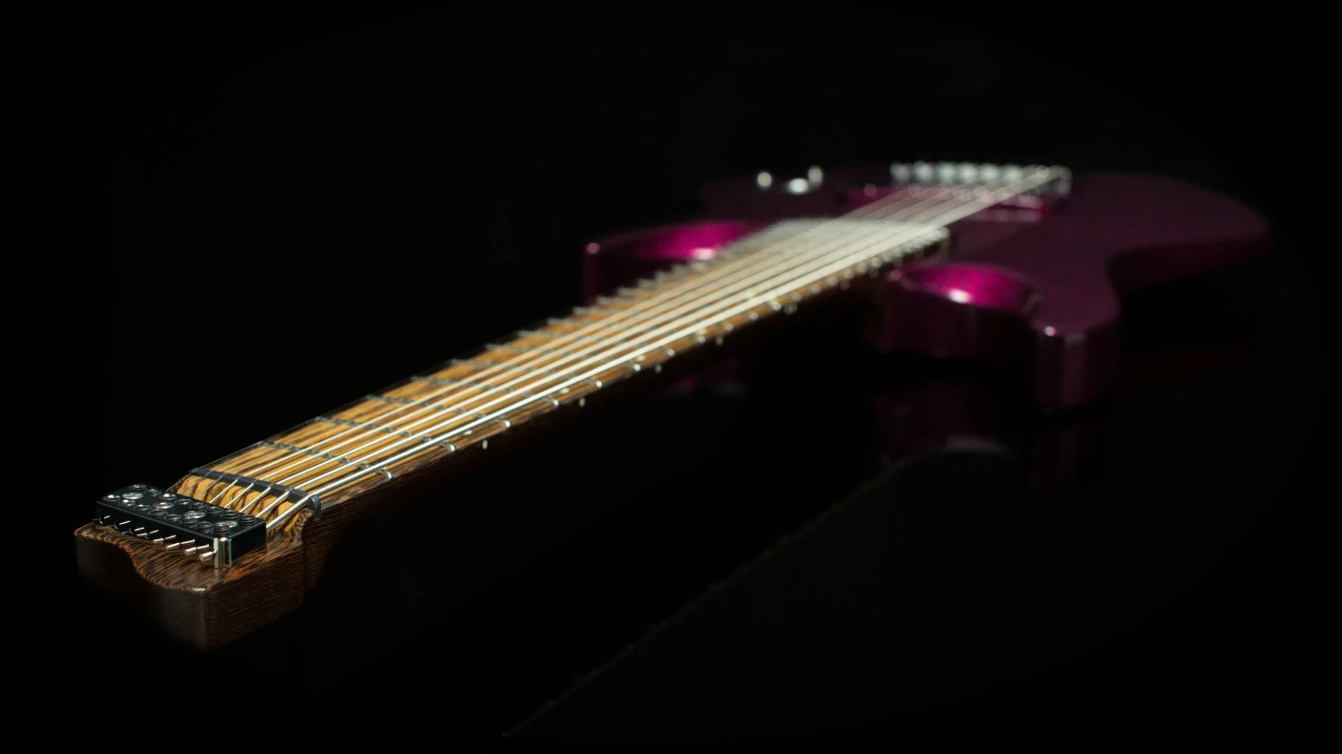 focussed view of the top of the neck showing the headless 8 string 'Headlock' string holder in chrome
