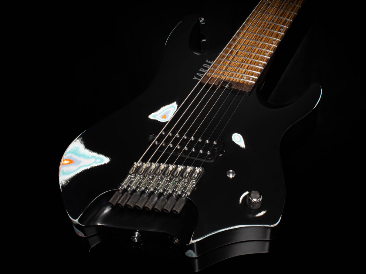 A 8 string headless - multiscale electric guitar with chrome hardware - 3/4 Body View