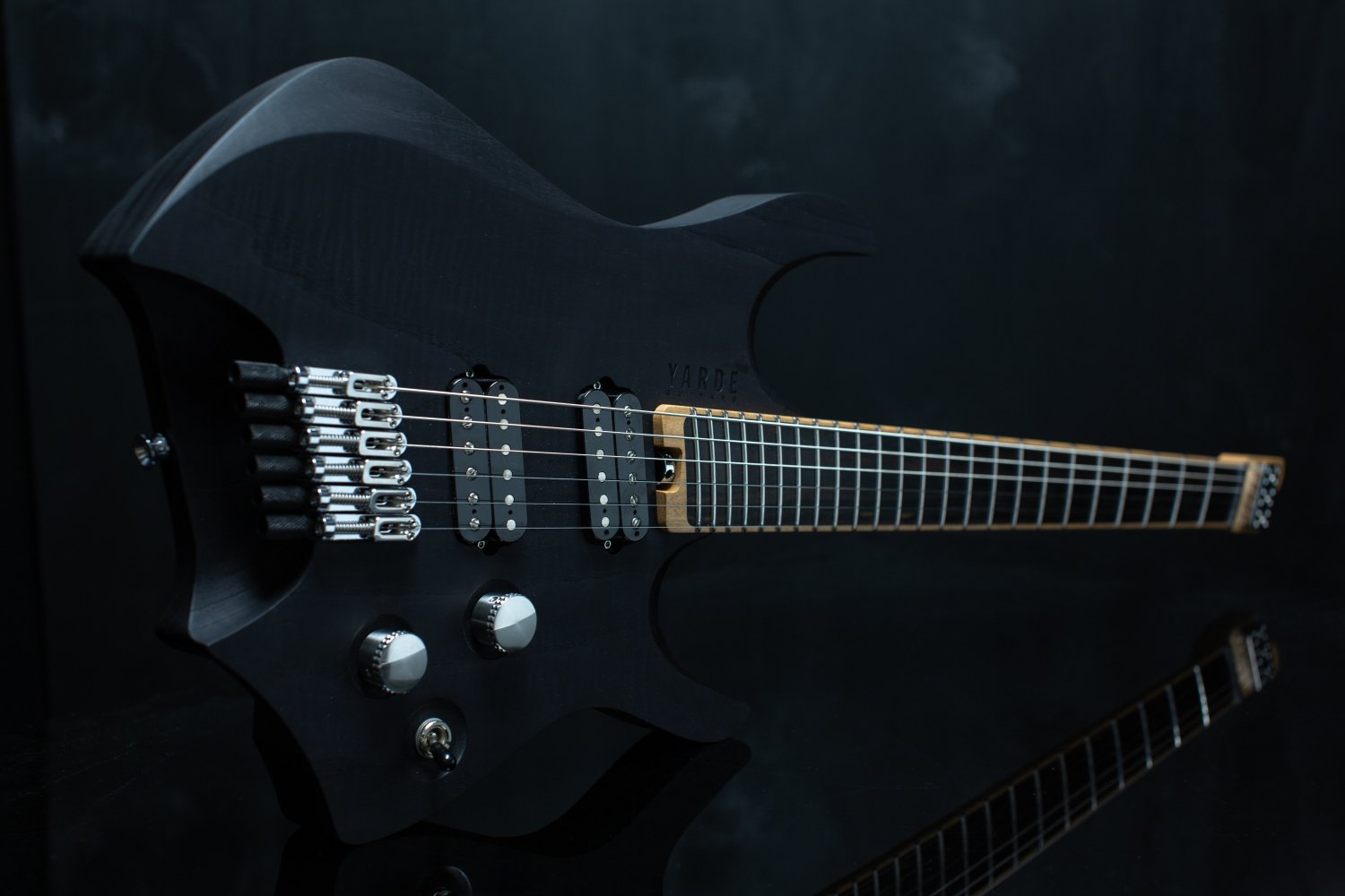A black stained headless - multiscale electric guitar with two angled humbucker pickups and a black background - Landscape view