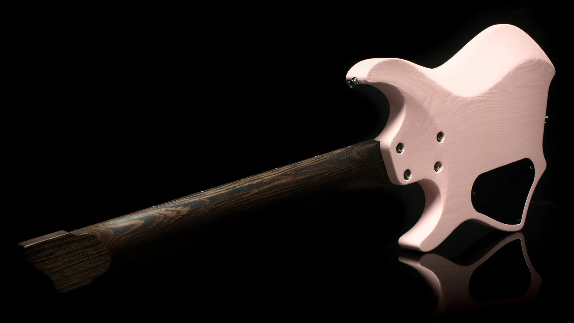 A pink 7 string headless - multiscale electric guitar back view showing the african wenge neck