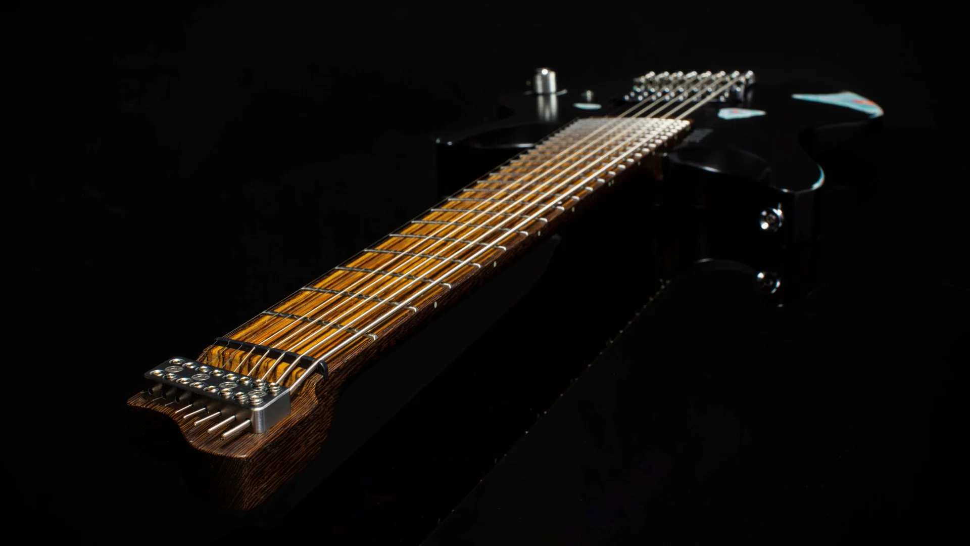 A 8 string headless - multiscale electric guitar focussing on the inlaid zebrano fretboard - 3/4 Neck View