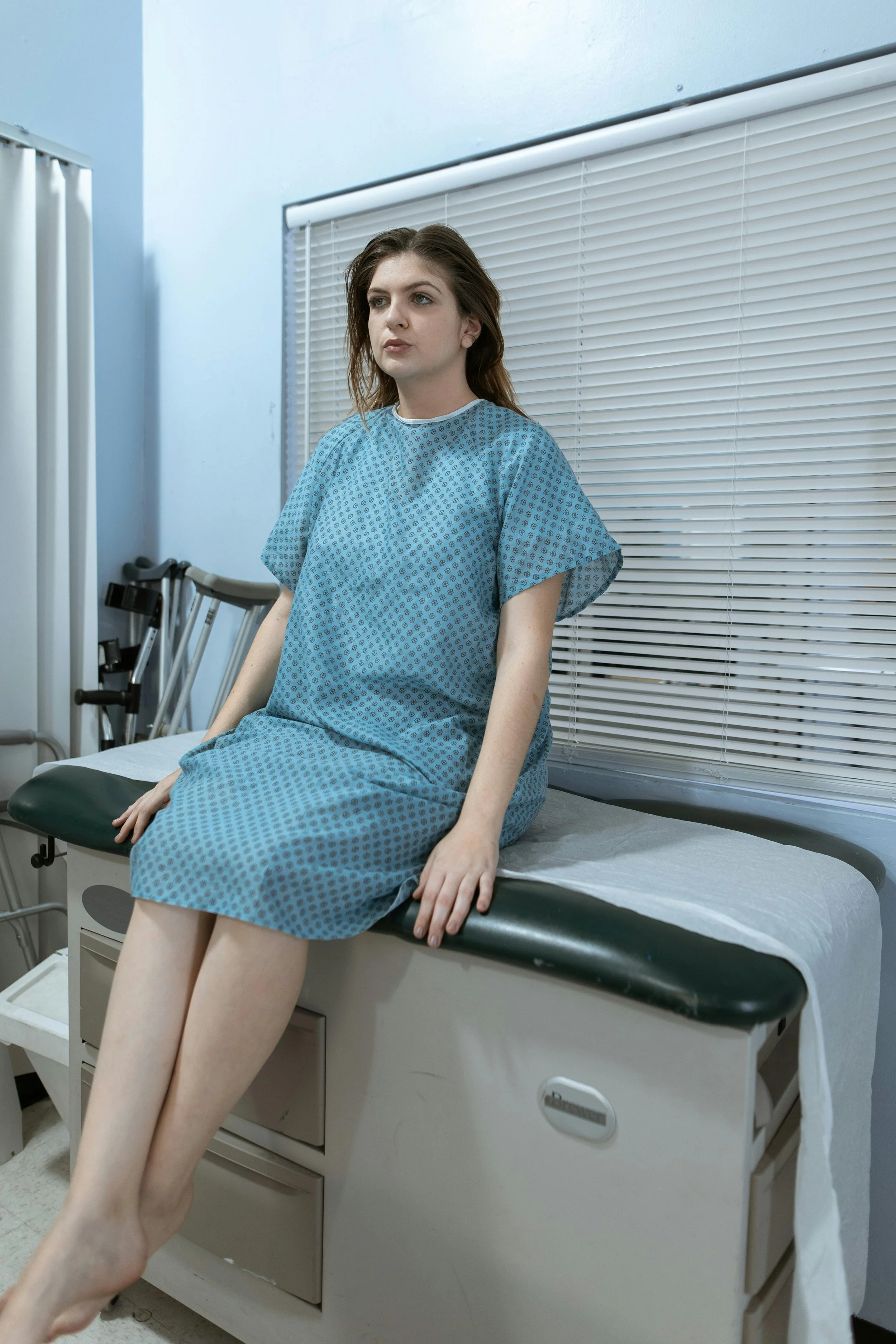 A woman at a doctor's appointment suffering from infertility or pregnancy loss.