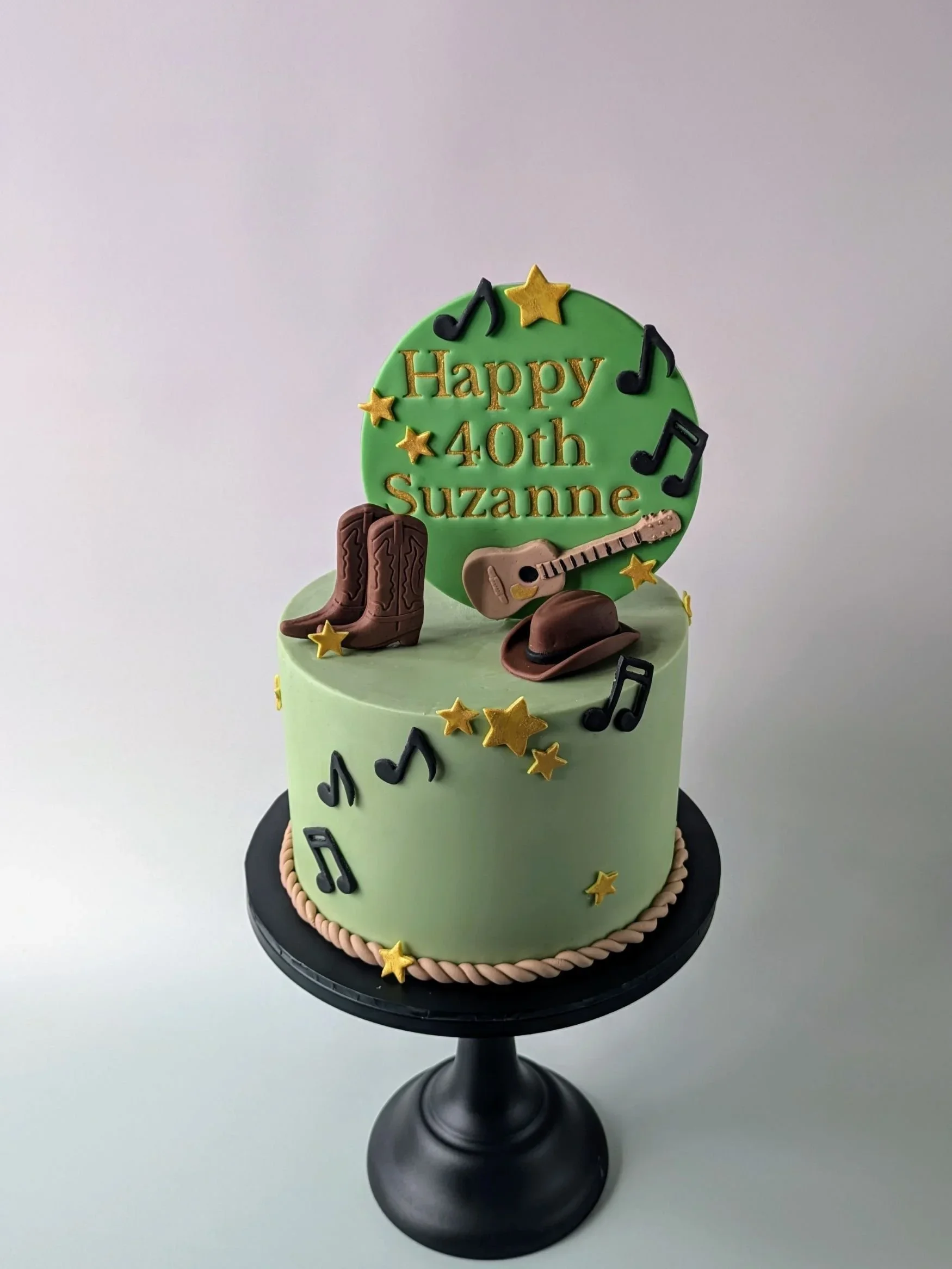 Green country western 40th birthday cake with handmade guitar and cowboy boots toppers, celebration cakes Bristol