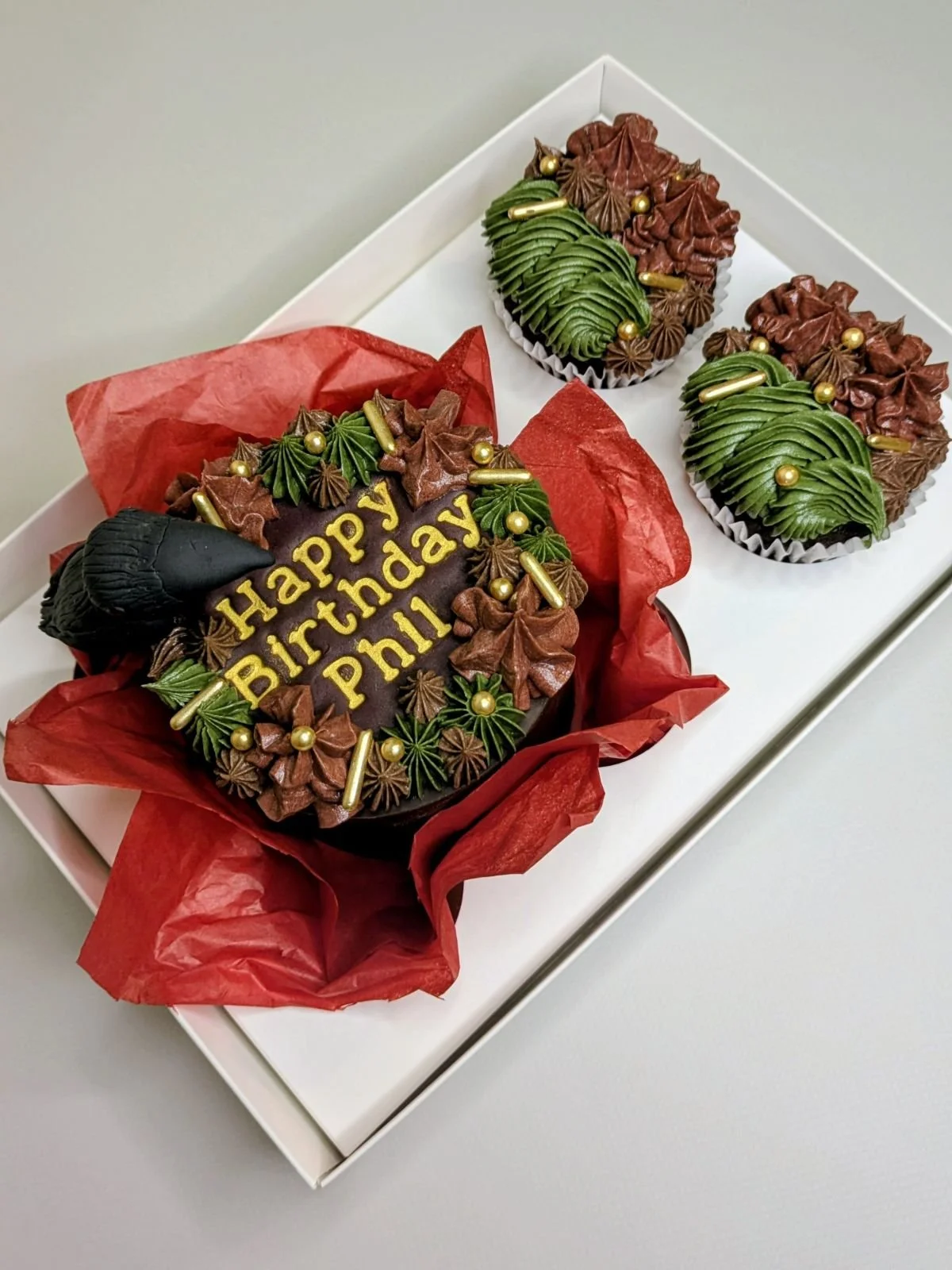 Green and red birthday bento with handmade sugar model of black crow vegan cake Bristol