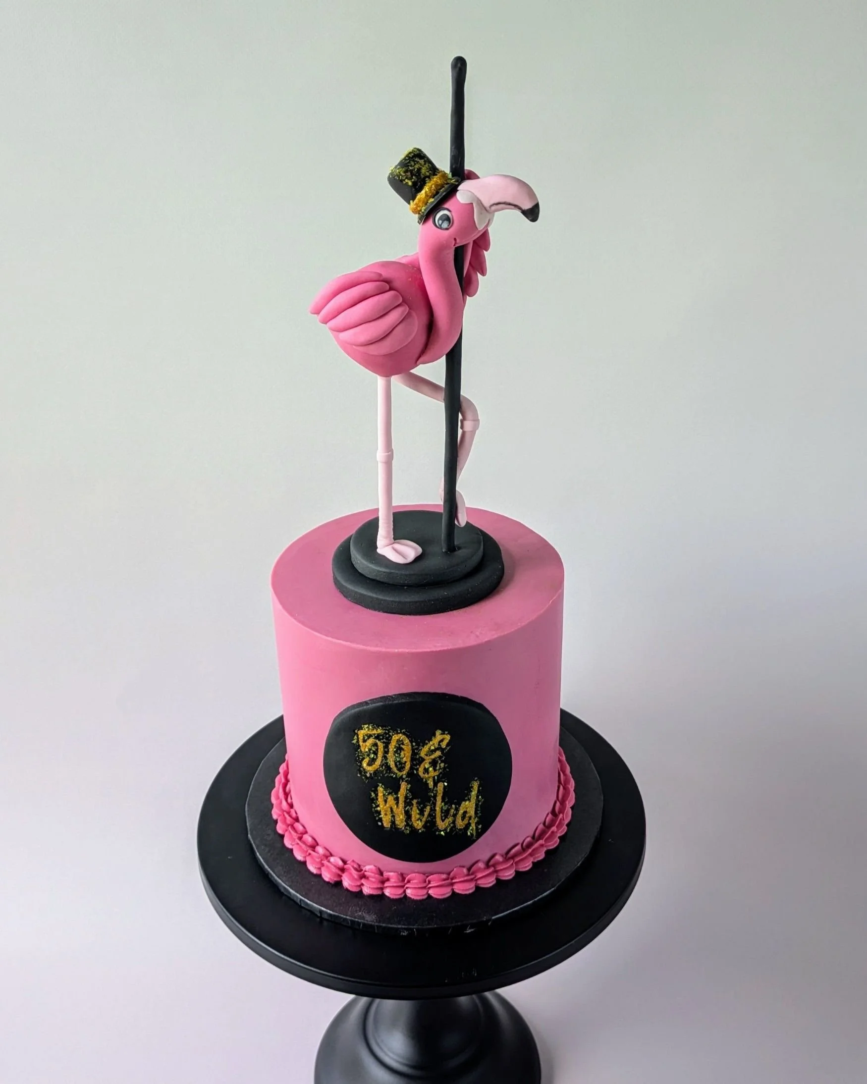 pink and black vegan pole dancing flamingo  themed 50th birthday cake.