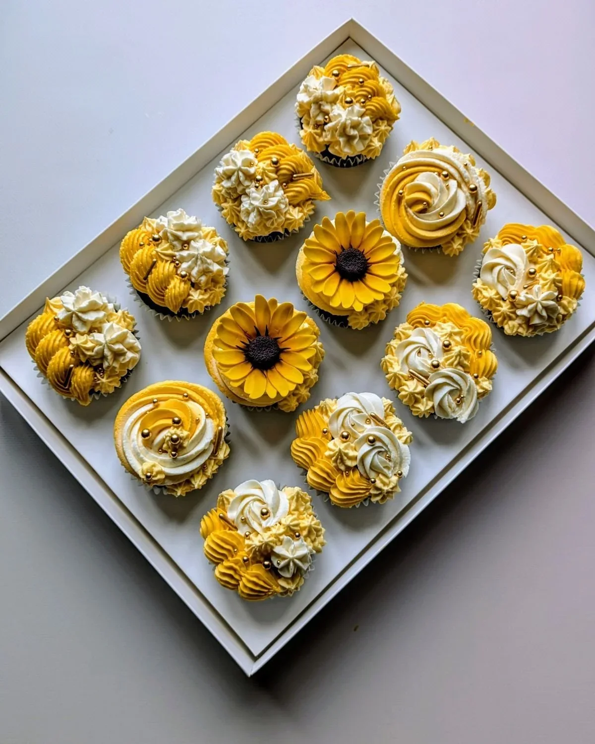 Vegan sunflower cupcakes with handmade sugar flowers and yellow buttercream from vegan cake shop in Bristol