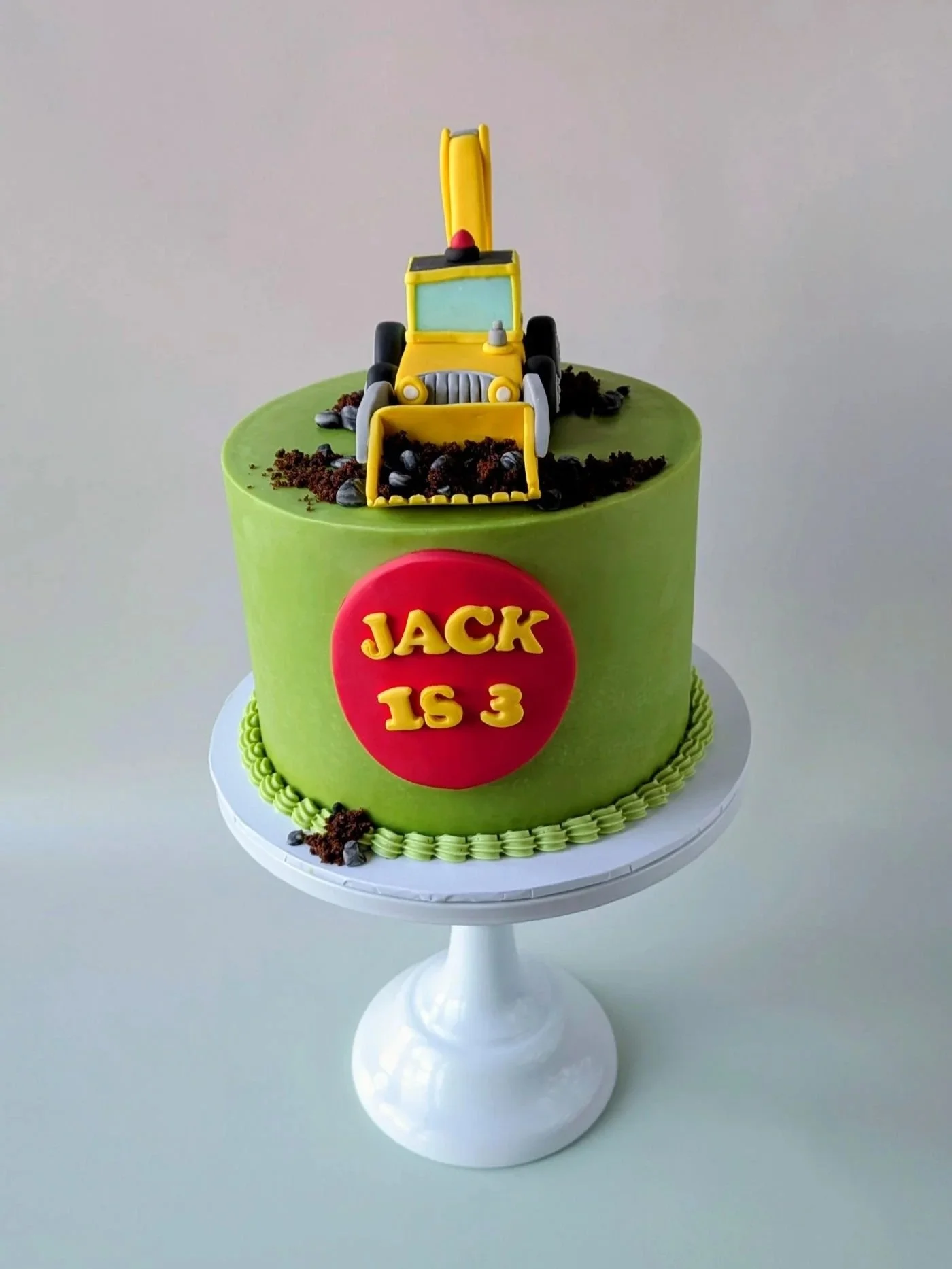 Chocolate digger birthday cake with handmade JCB topper and construction theme from vegan cake shop in Bristol.