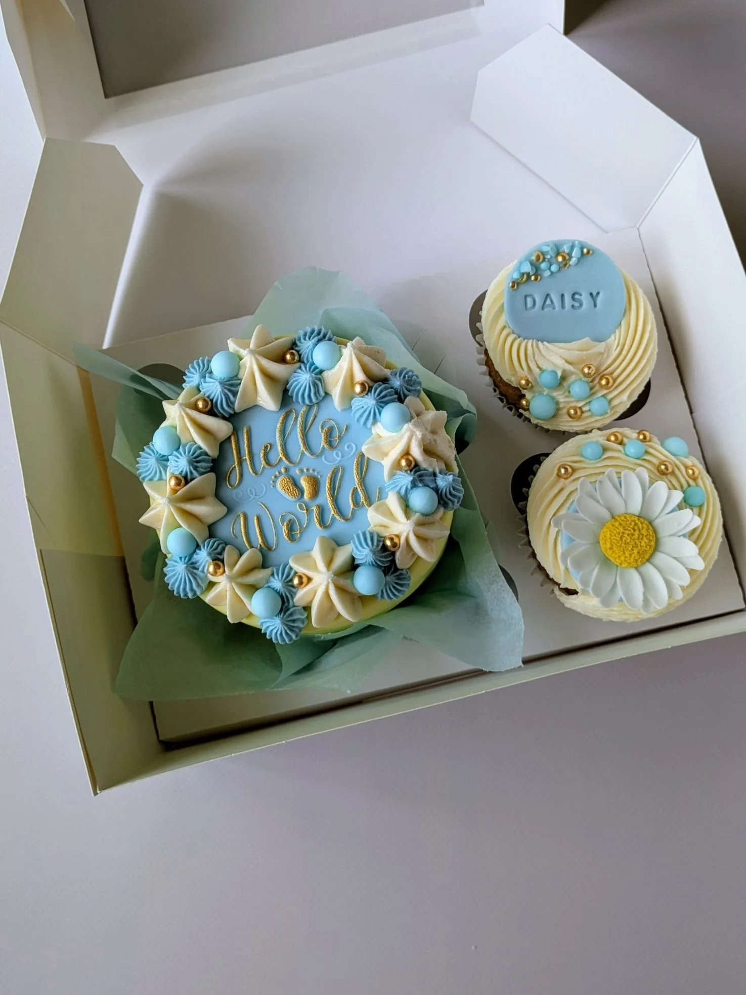 Pastel blue and yellow baby shower bento with daisy topper vegan cake made in Bristol