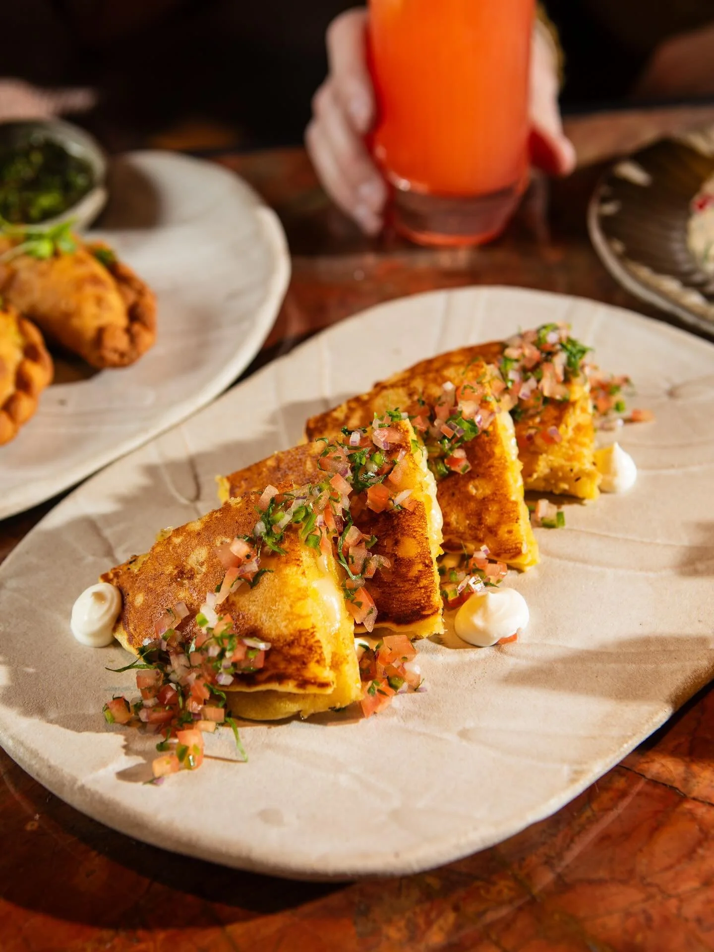 Our Cachapas bring Venezuelan roots and a whole lot of flavor &mdash; sweet corn pancakes loaded with Spanish Manchego, mozzarella, sour cream, and pico de gallo. 🇻🇪