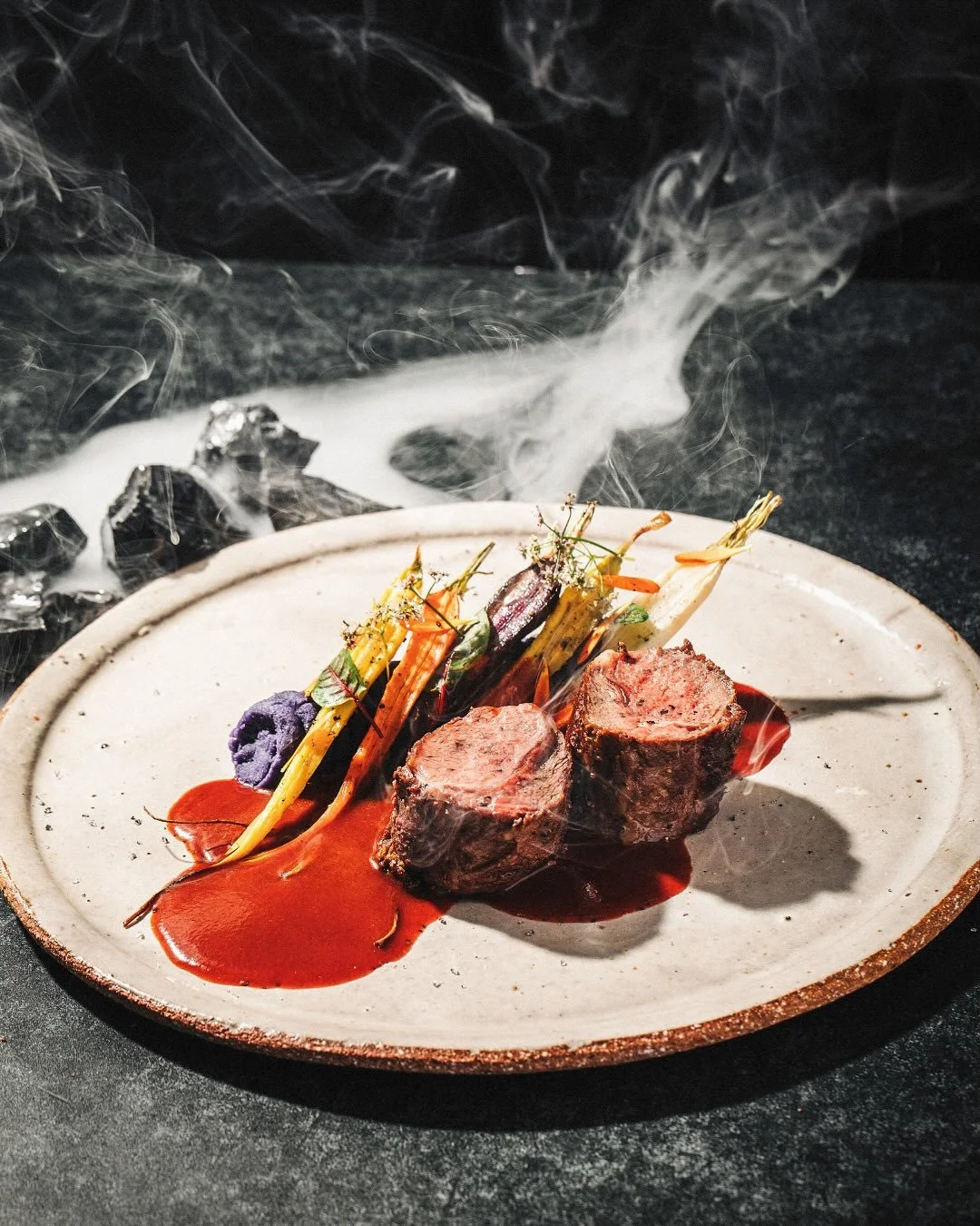 An edible ofrenda: Beef Tenderloin with purple potato mash, heirloom carrots, and chipotle hibiscus sauce. Celebrate D&iacute;a de los Muertos with this seasonal dish, October 1 - November 3.