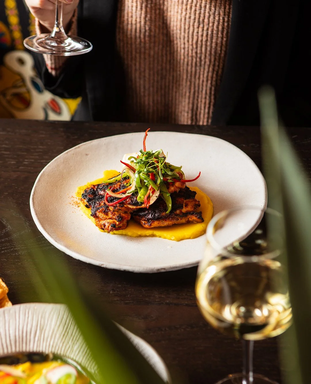 Grilled over an open flame, marinated in achiote and chili, and served with criolla salad &ndash; our Cusco Chicken is a love letter to Peru's coast. Every bite speaks Spanish.