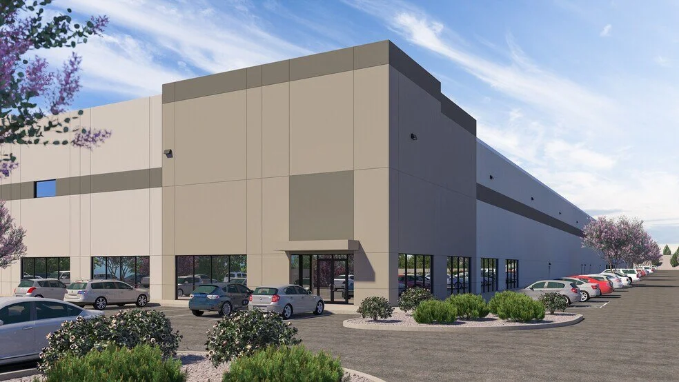 Digital rendering of a large beige commercial warehouse with parking lot and parked cars, landscaped with bushes and trees, under a partly cloudy sky.