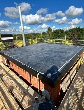 Flat roof with solar panel installation under blue sky with clouds