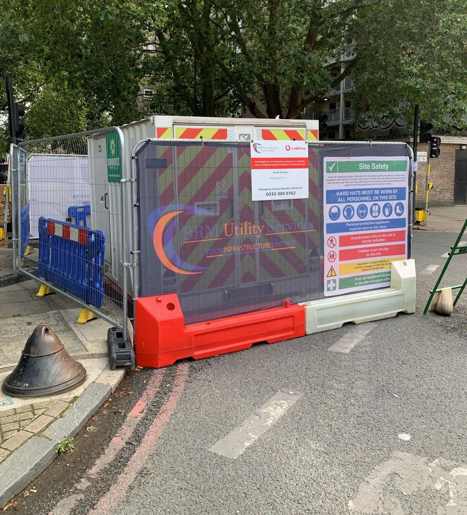 Street construction site with safety barriers and signs