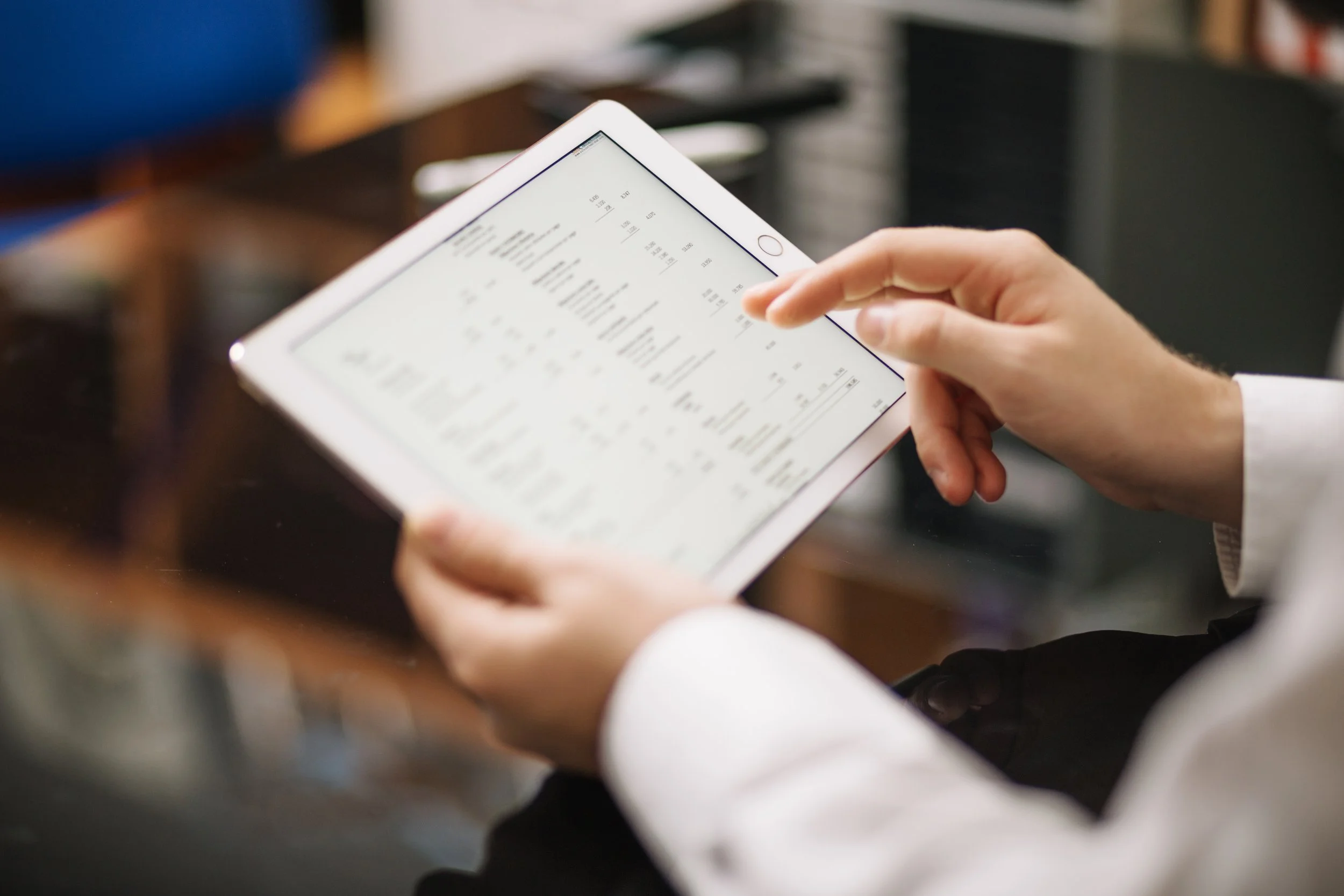Person using a tablet to view a spreadsheet