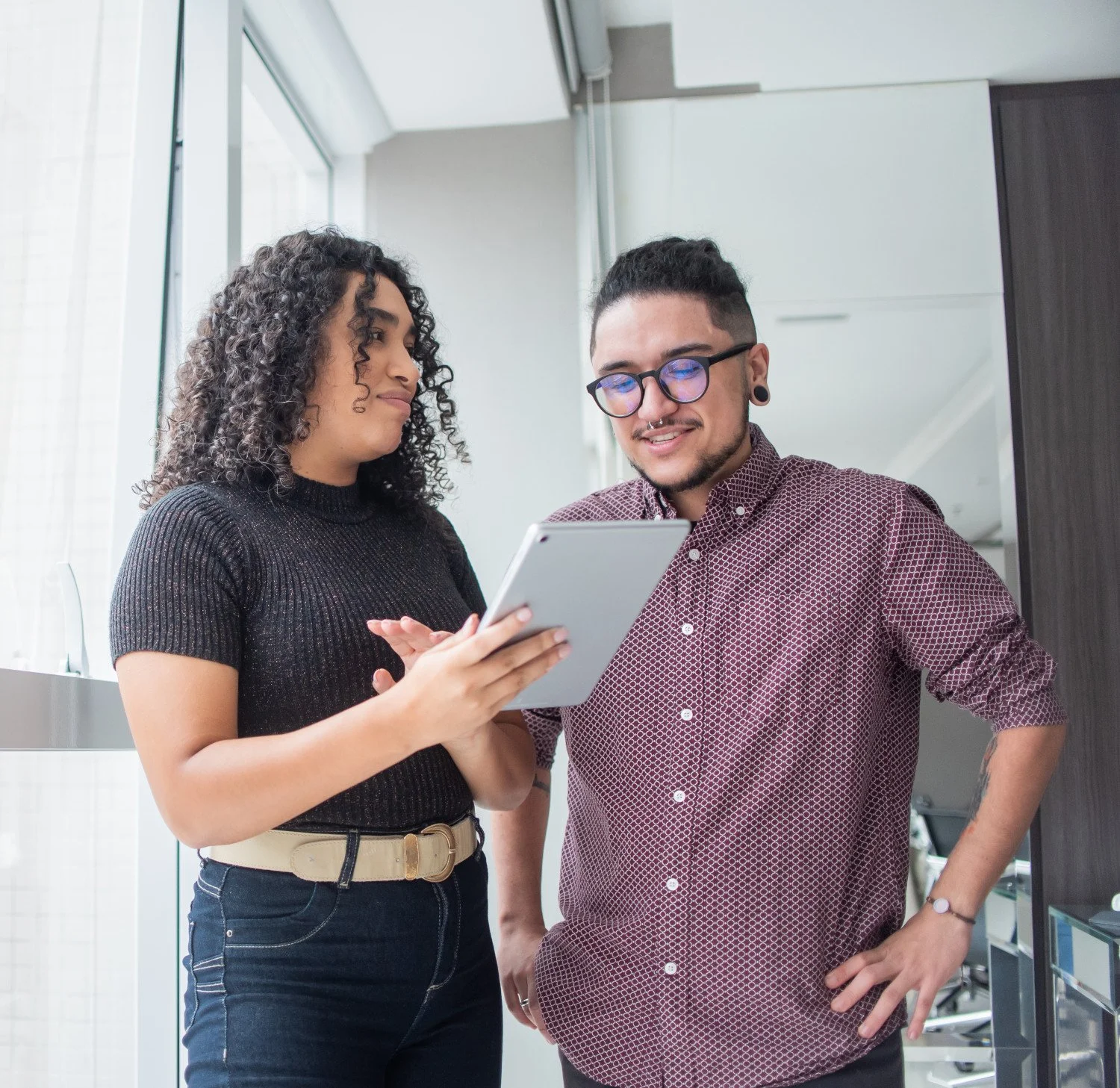 Two professionals of diverse race and gender speaking to each other in a business context