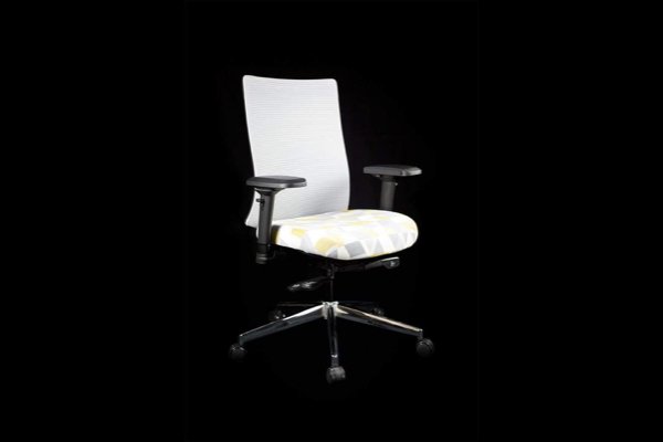 A white office chair against a black background. 