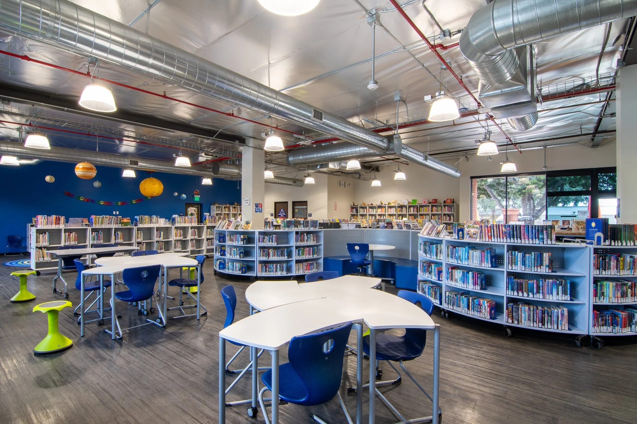 Curved bookshelves, wobble seating and mobile desks have turned this library into a collaborative, multi-function space! 
