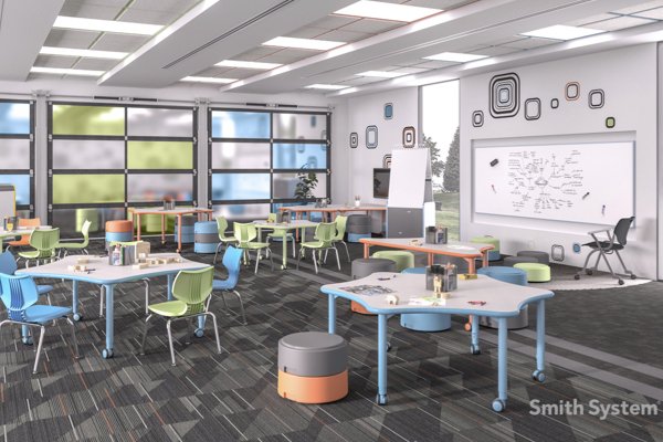 A mock classroom filled with star shaped tables and blue and green chairs. 
